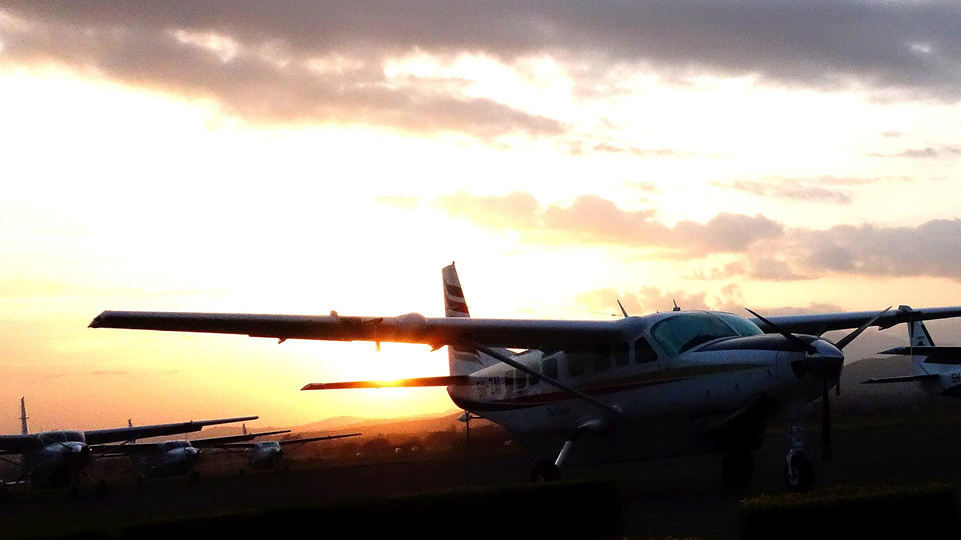 A light aircraft on a bush airstrip in the Okavango Delta with floodplains stretching to the horizon