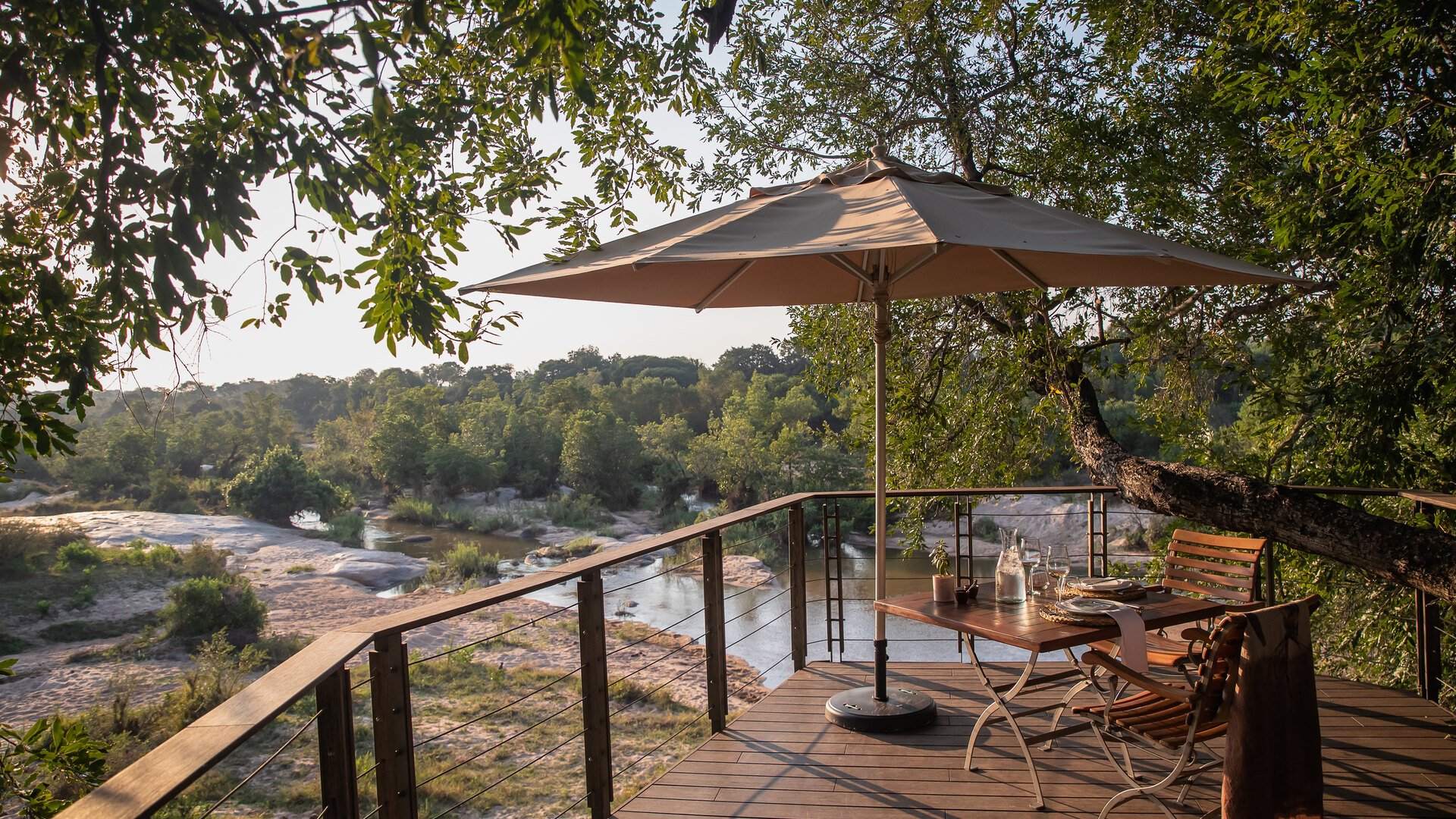 Dulini Private Game Reserve river deck overlooking the Sand River in Sabi Sands with outdoor seating and natural bush views