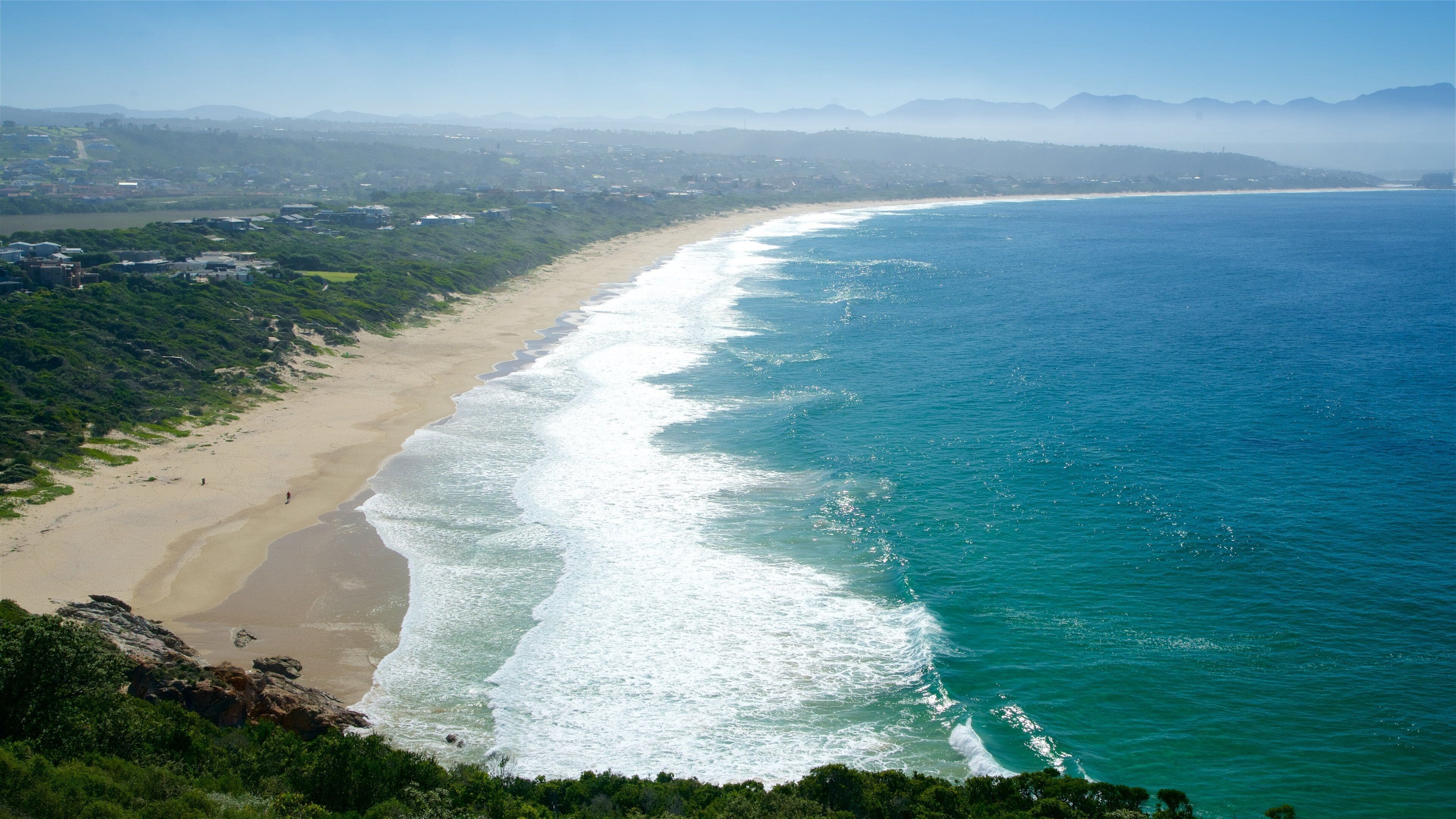 Aerial view of the Robberg Peninsula coastline where indigenous forest meets the Indian Ocean on a Garden Route tour in South Africa