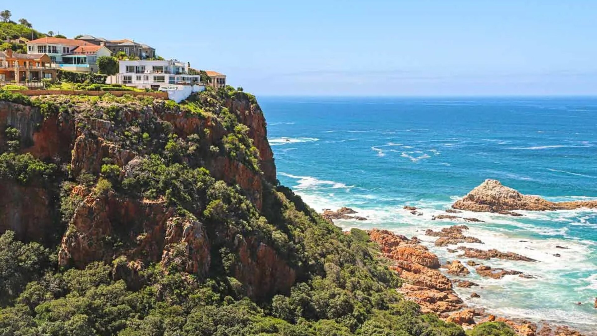 The rugged Garden Route coastline meeting indigenous forest at golden hour in South Africa