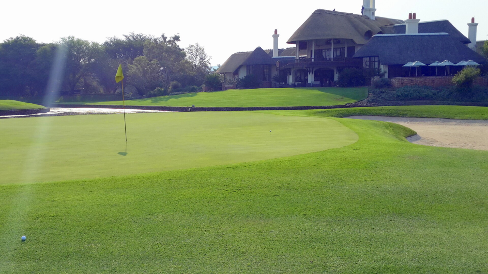 The 9th green and clubhouse at Leopard Creek Country Club on the banks of the Crocodile River