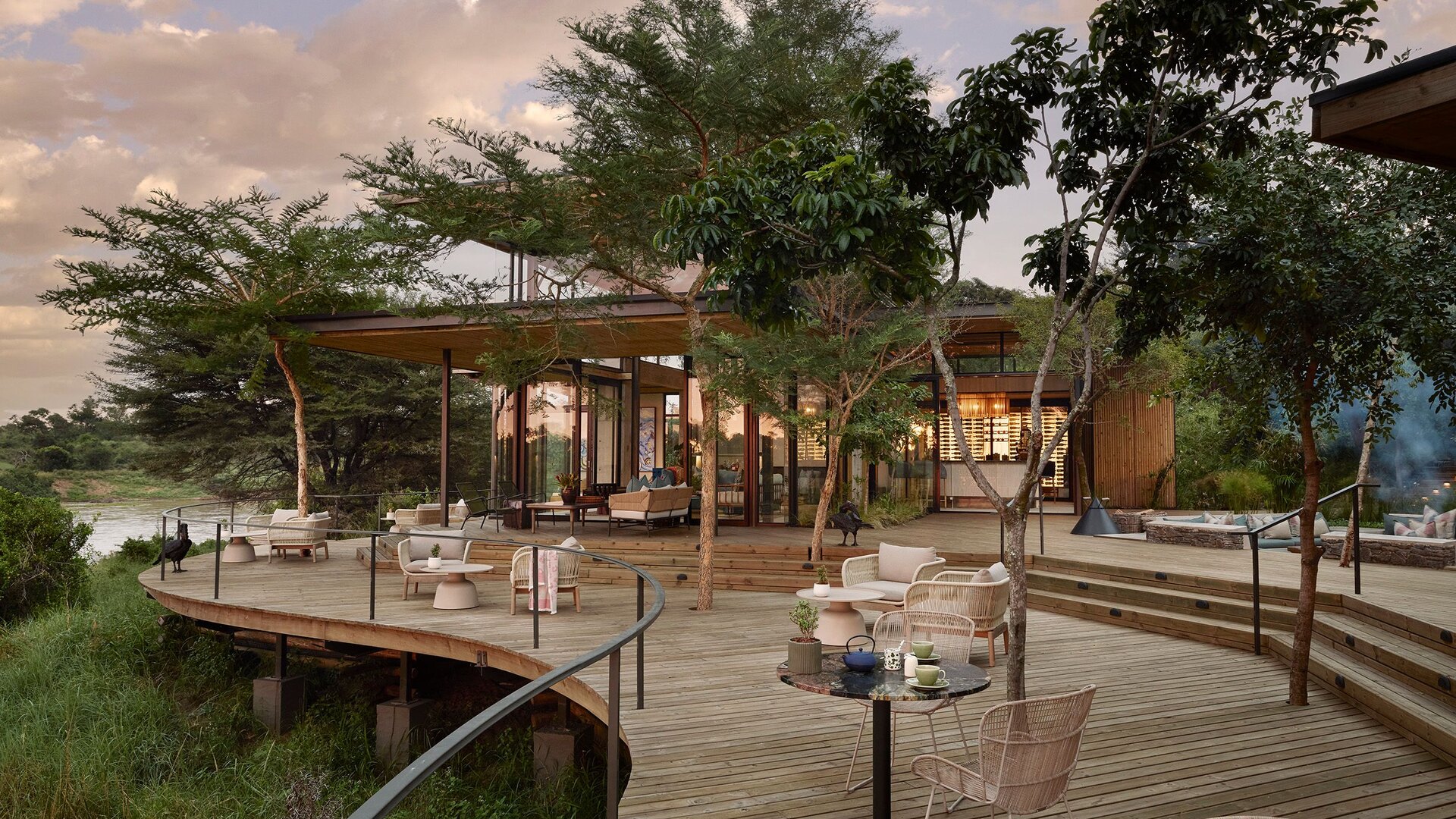 Lion Sands Ivory Lodge deck at golden hour overlooking the Sabie River in the Sabi Sand Game Reserve