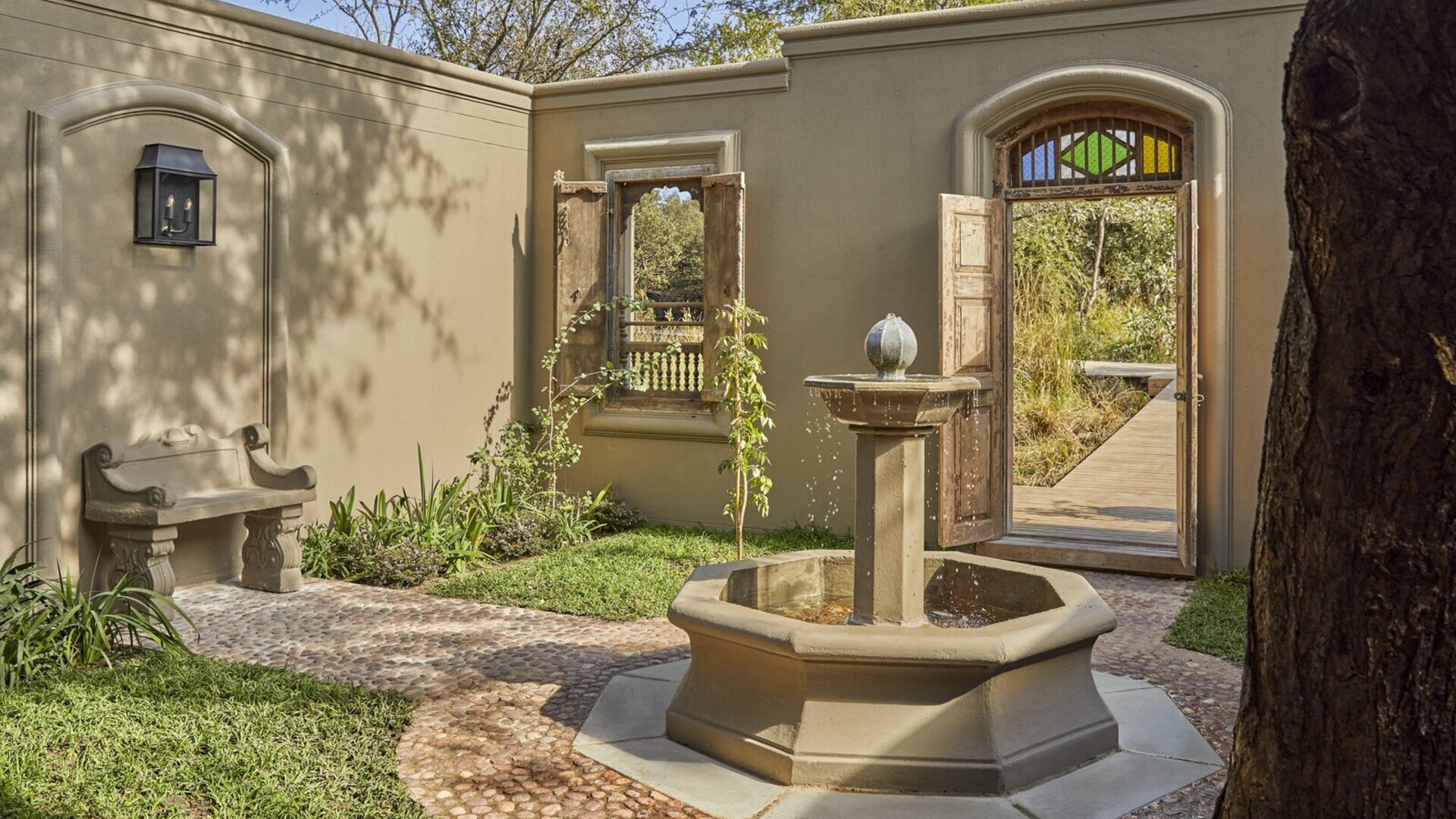 A luxury honeymoon suite with a private deck and plunge pool overlooking the African landscape at golden hour
