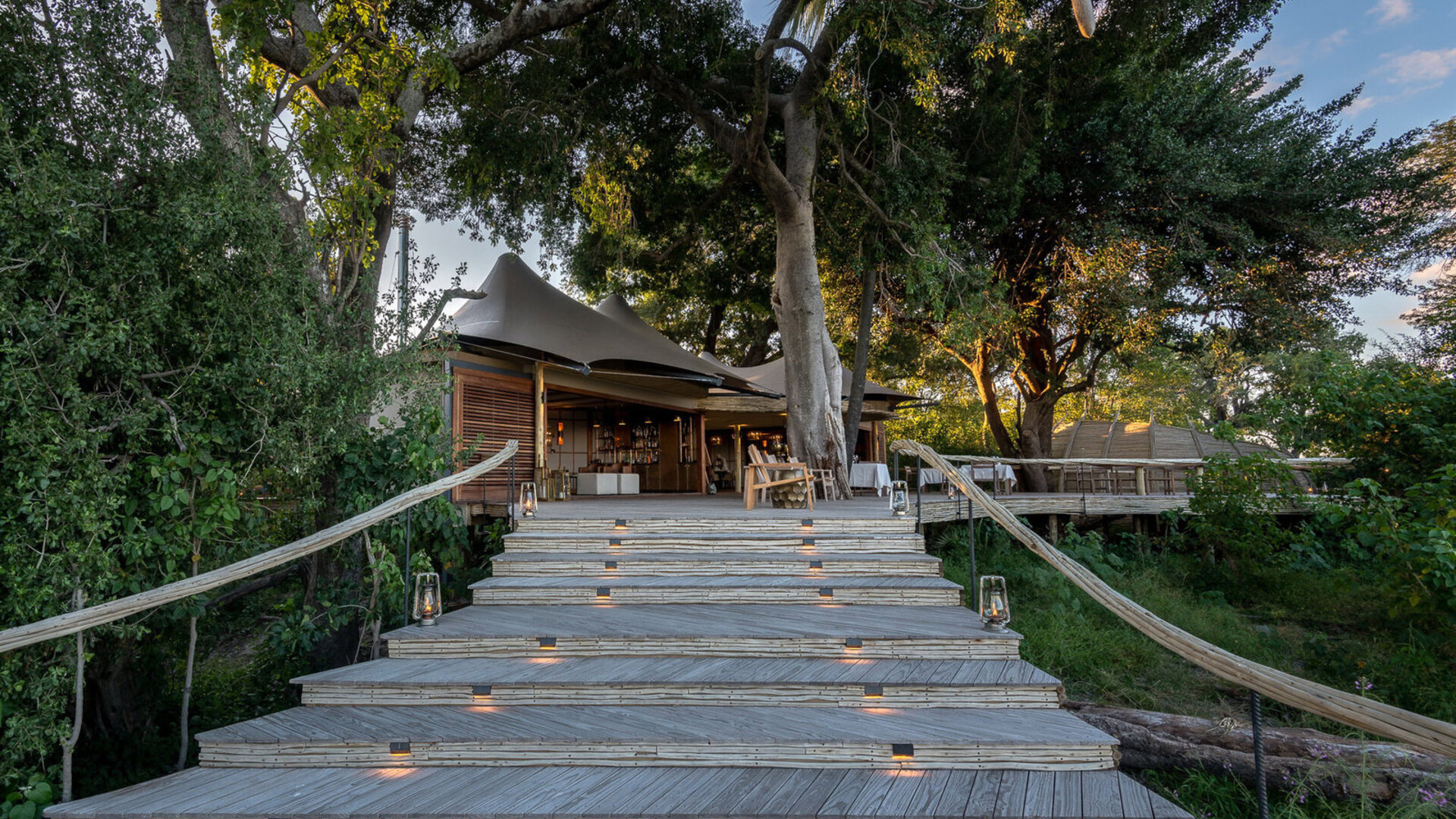 Elevated main-camp deck at a luxury Okavango Delta lodge overlooking the floodplain