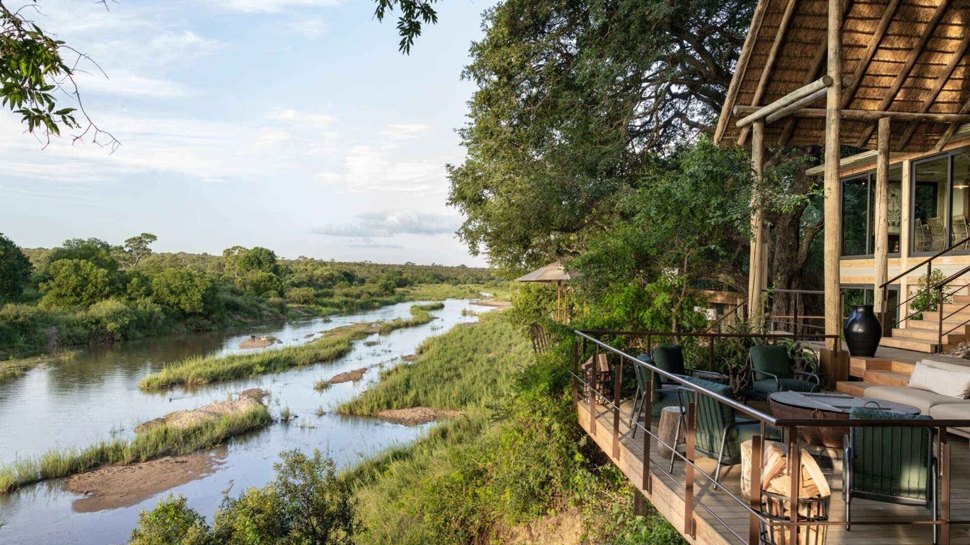 Elevated river-view deck at a luxury Sabi Sands lodge at golden hour