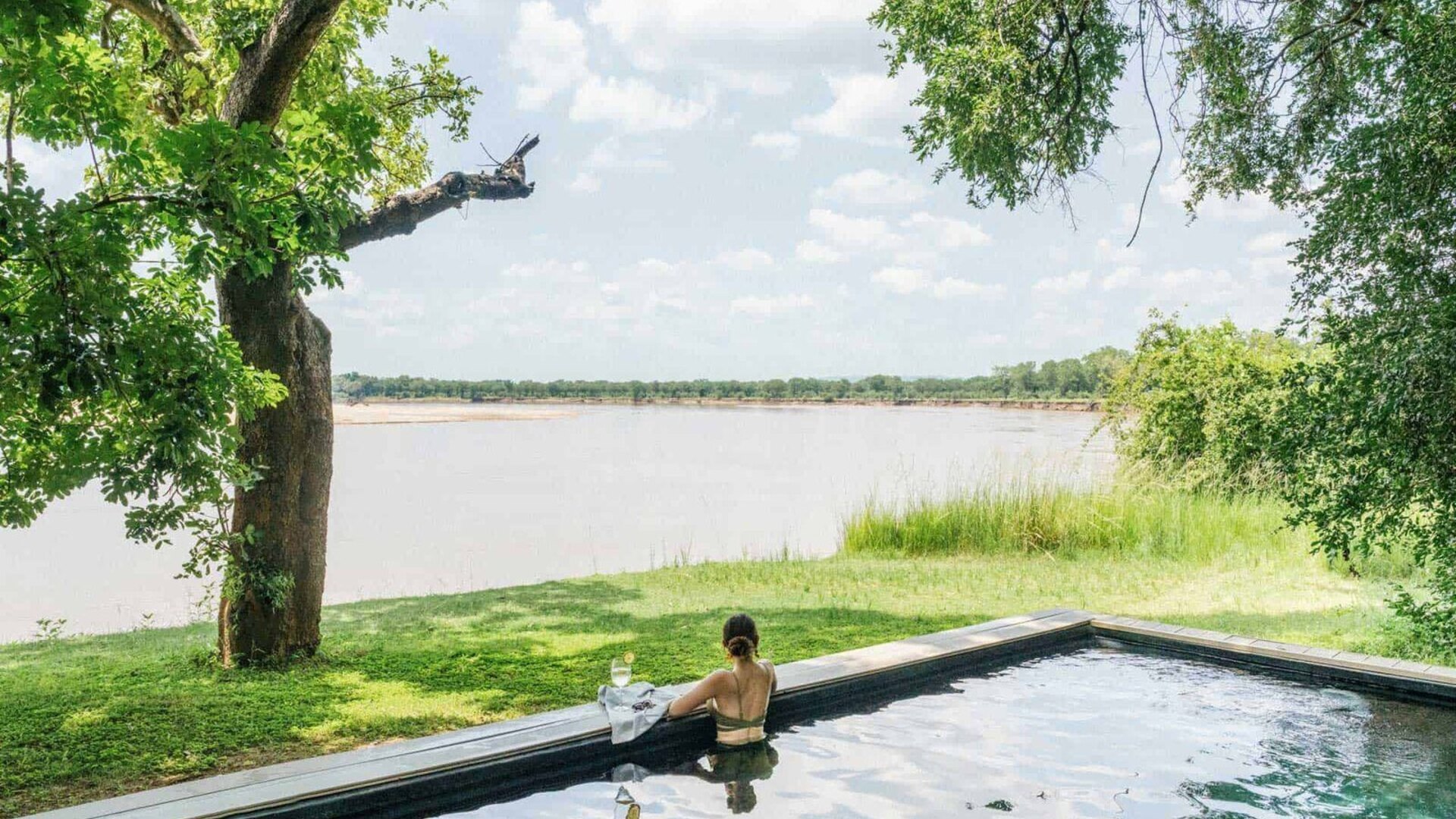 Luxury riverside lodge overlooking the Luangwa River at golden hour