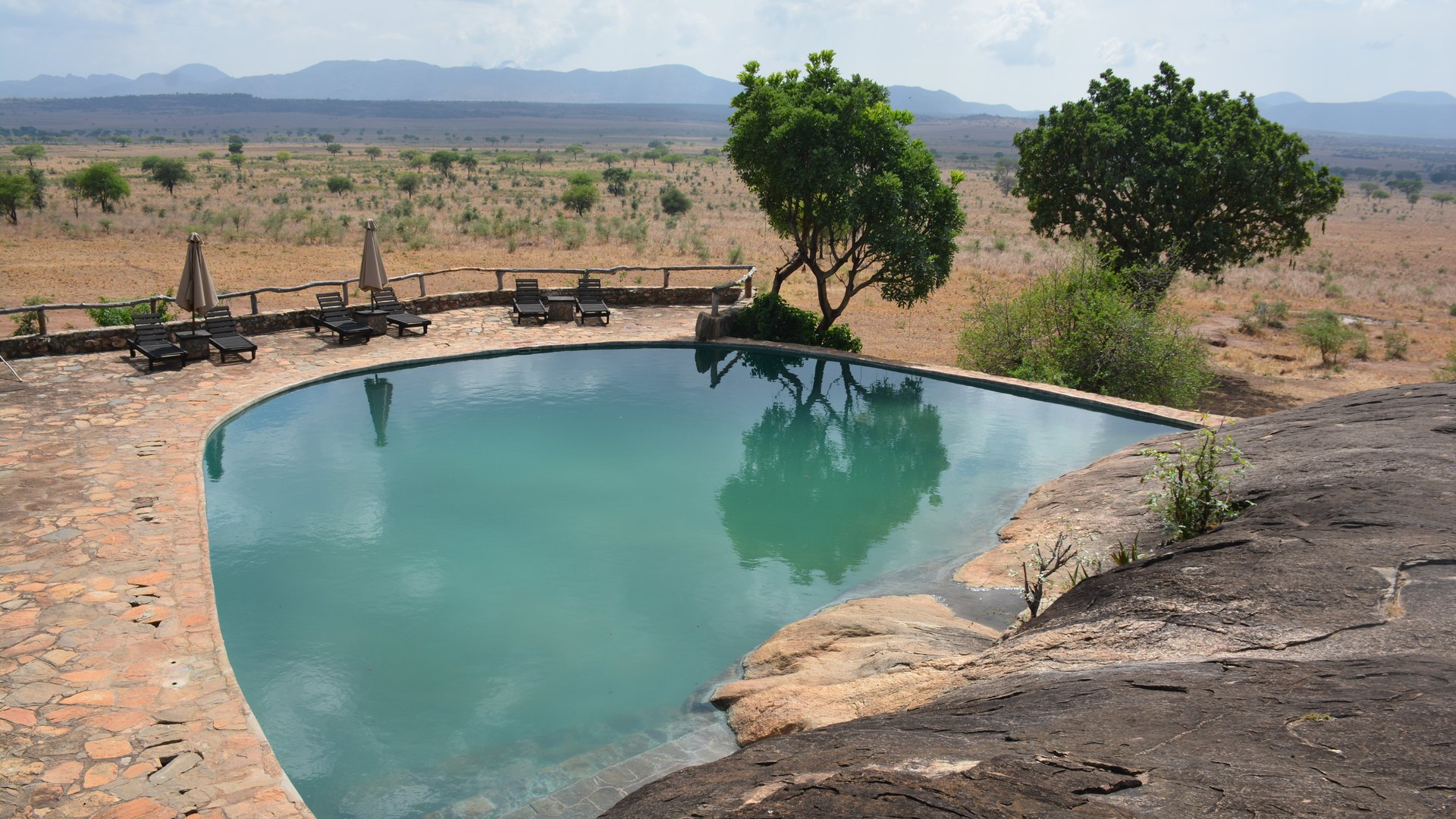 An infinity rock pool at a luxury safari lodge overlooking the Tanzanian savanna