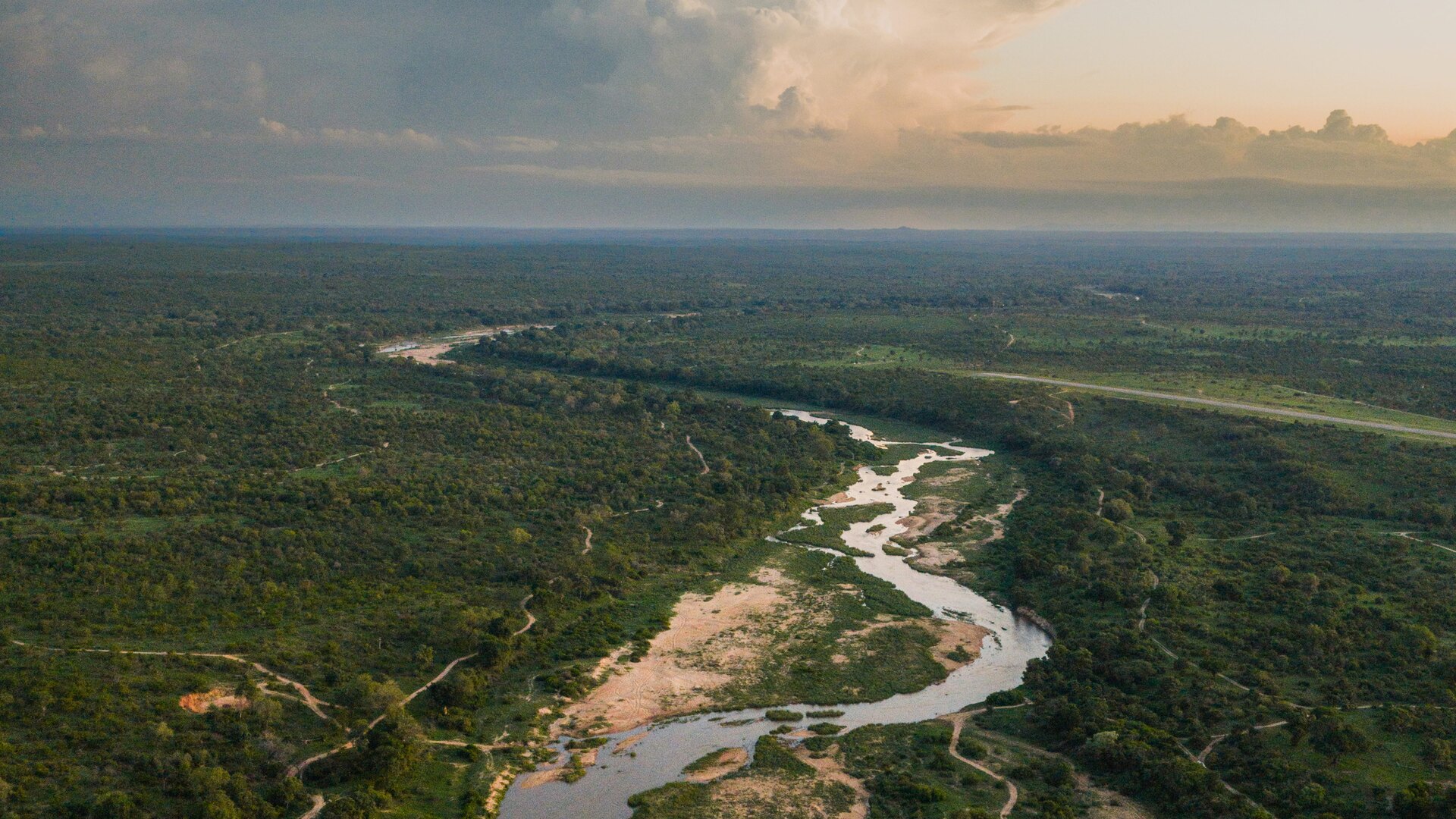 Aerial view of the Sand River winding through MalaMala Game Reserve at golden hour in the Sabi Sand