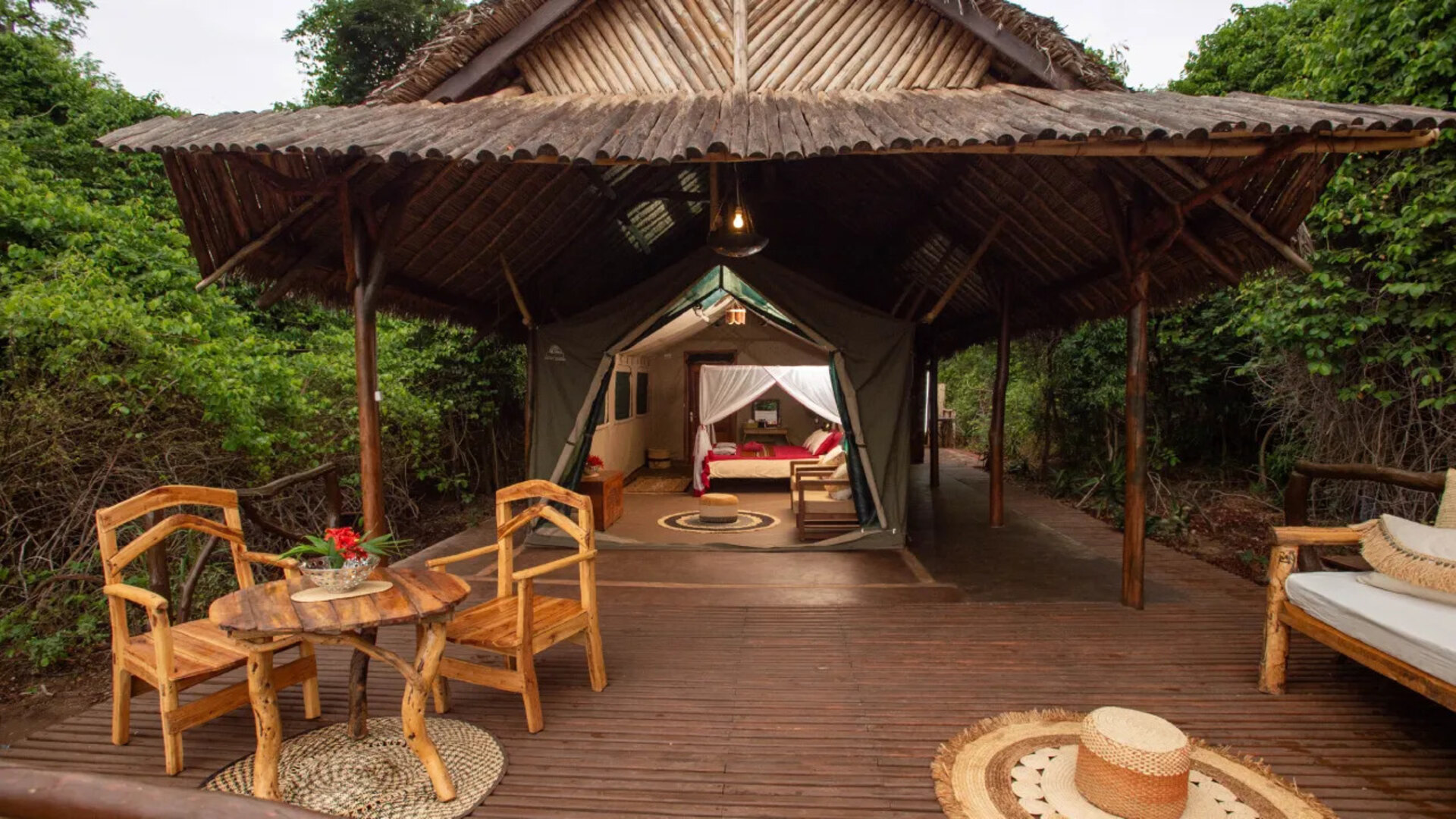 Aerial view of Mandrare River Camp's tented suites nestled beneath ancient tamarind trees on the banks of the Manampanihy River in southern Madagascar