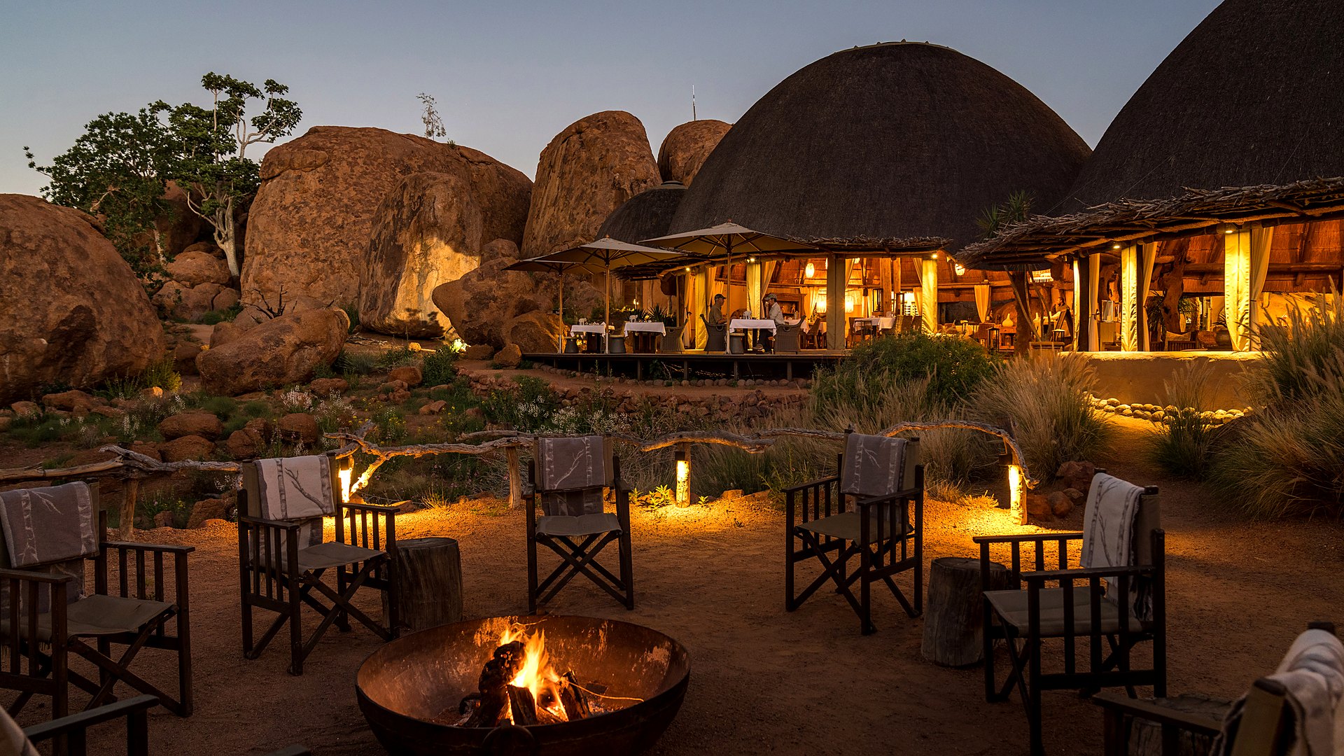 Thatched dome suites of Mowani Mountain Camp among the terracotta boulders of Damaraland