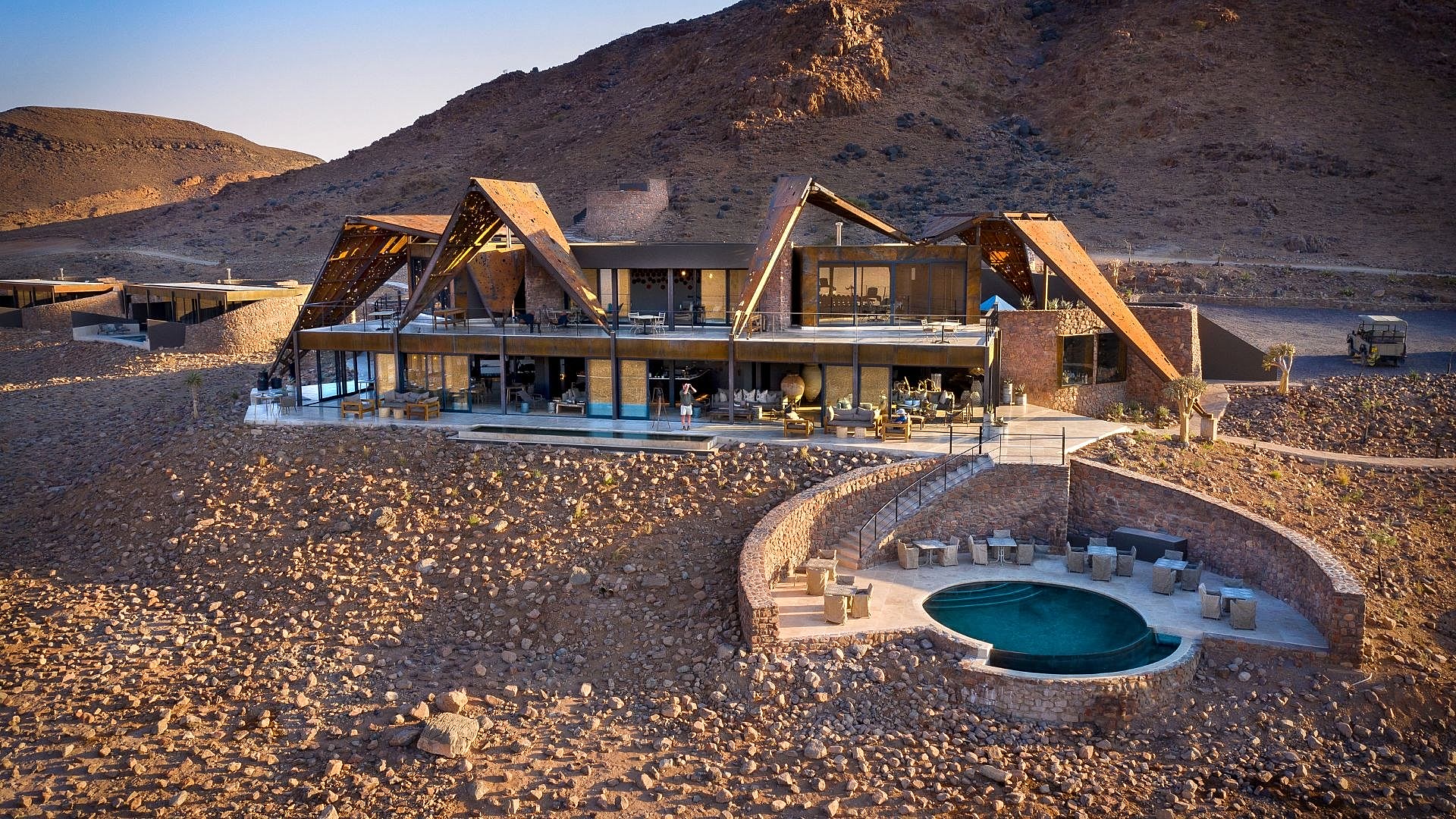 A luxury desert lodge overlooking the red dunes of Sossusvlei, perfect for a Namibia honeymoon package