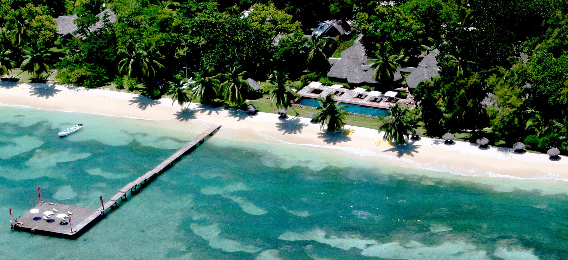 Aerial view of Princesse Bora Lodge & Spa's beachfront villas and heated pool on Île Sainte-Marie, Madagascar's premier whale-watching island