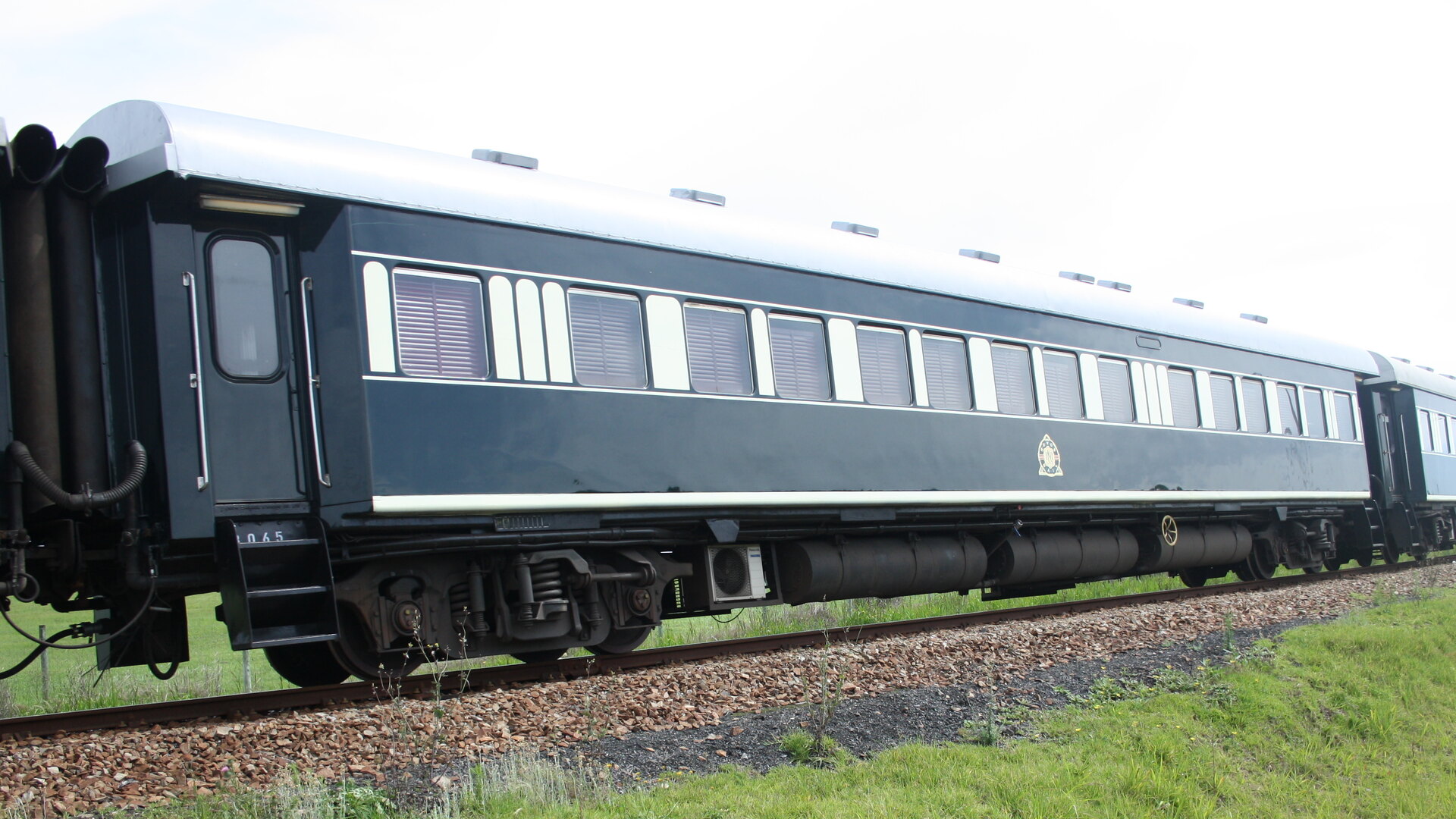 A luxury train carriage rolling through the South African countryside — the golden age of rail travel