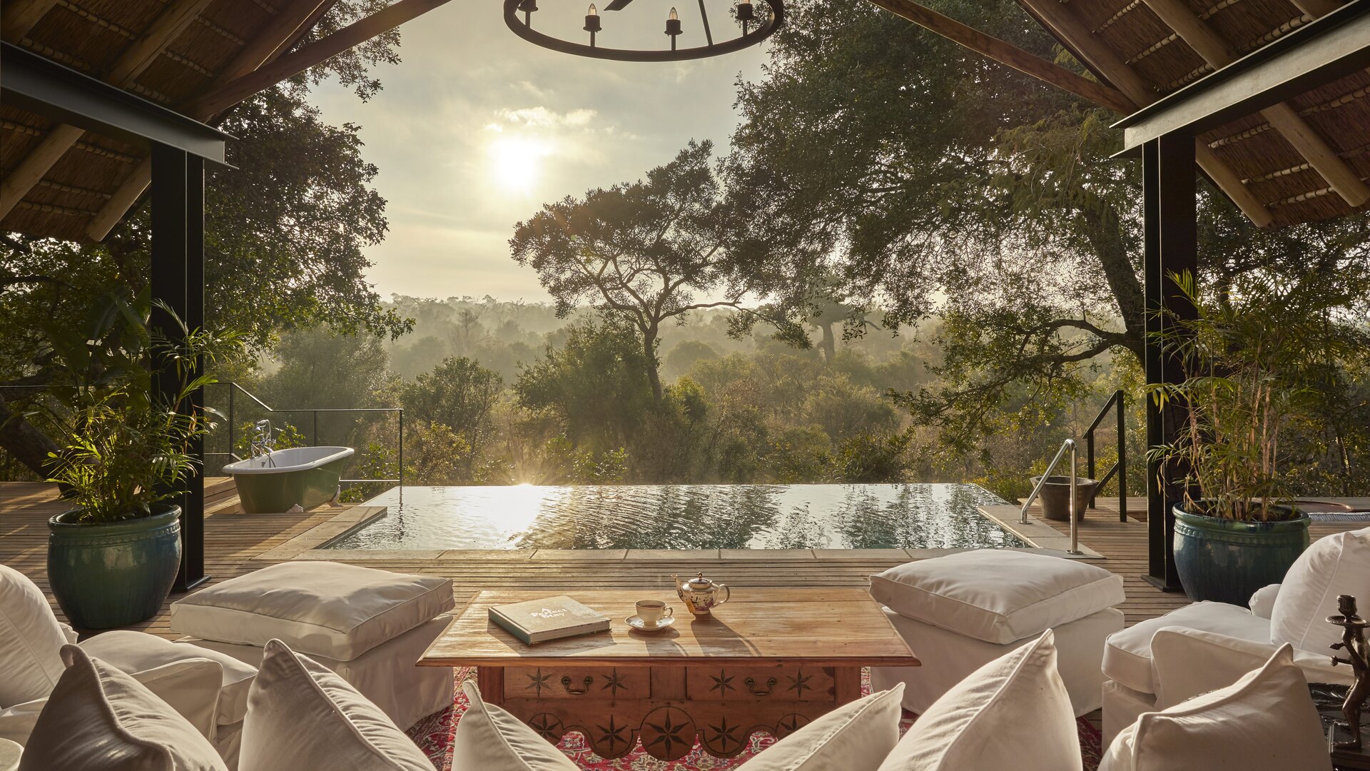 The Royal Suite's private pool deck cantilevered over the Thornybush bush at Royal Malewane at golden hour