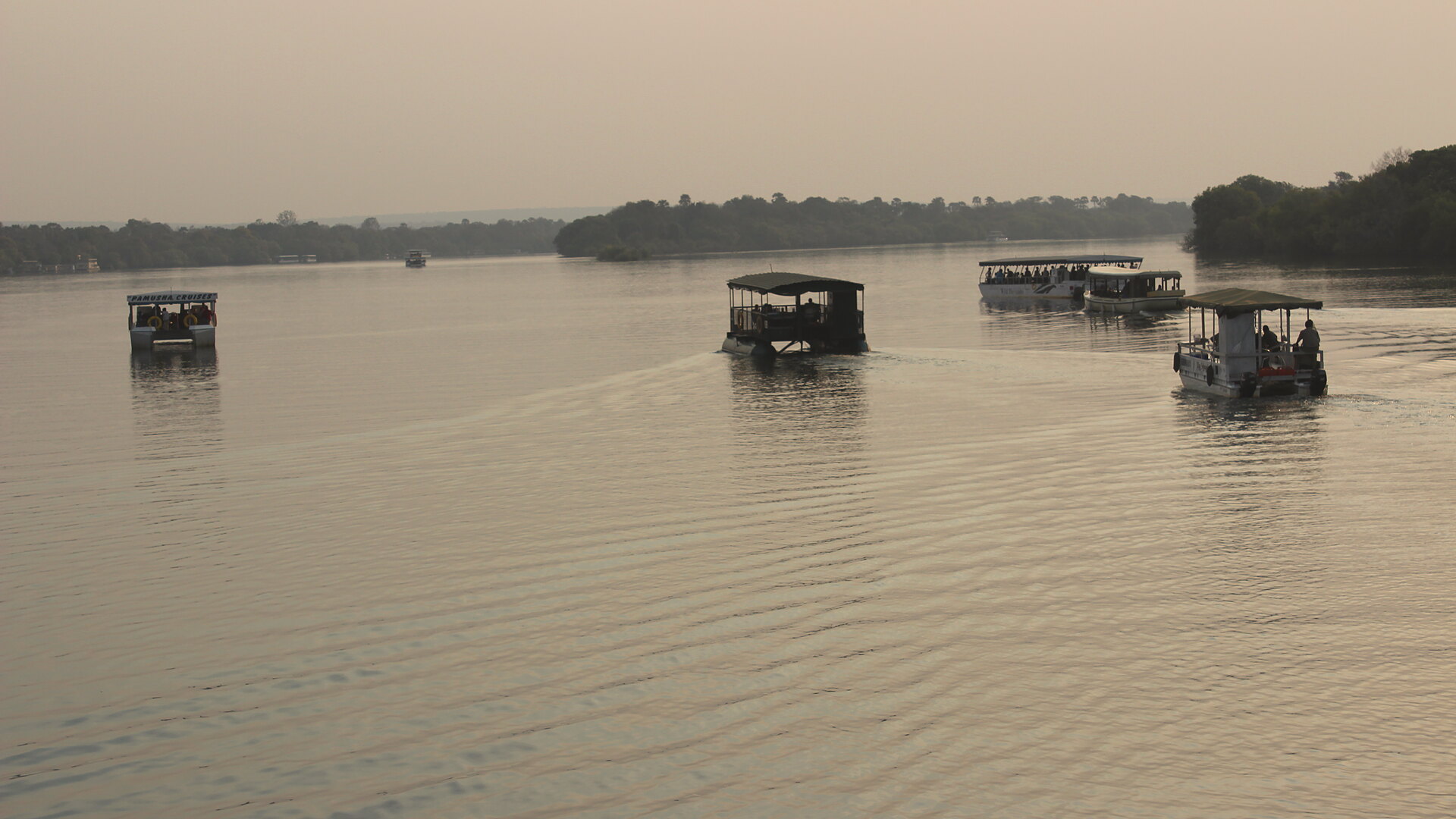 Canoes at sunset on the Zambezi by Sausage Tree Camp