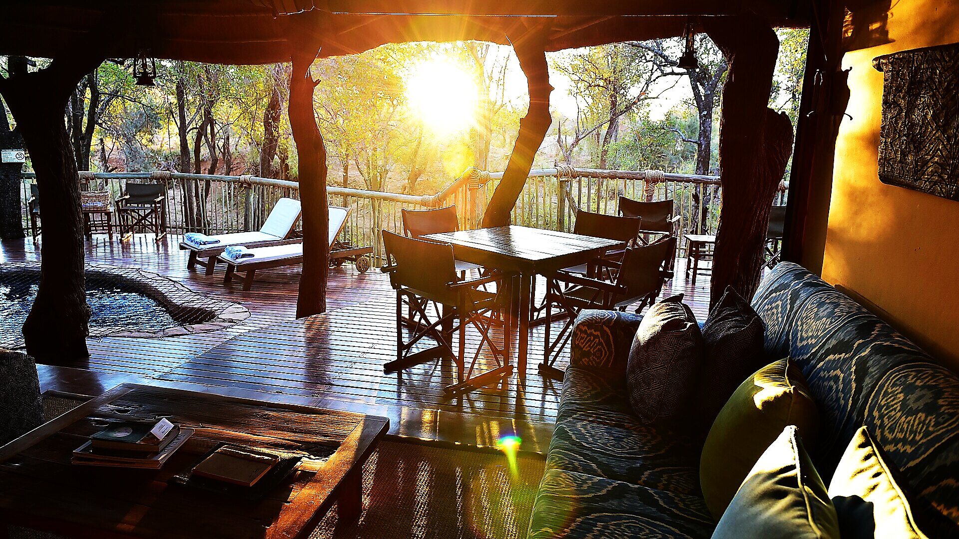 Warm-lit open-air lounge overlooking the Zambezi at Sindabezi Island