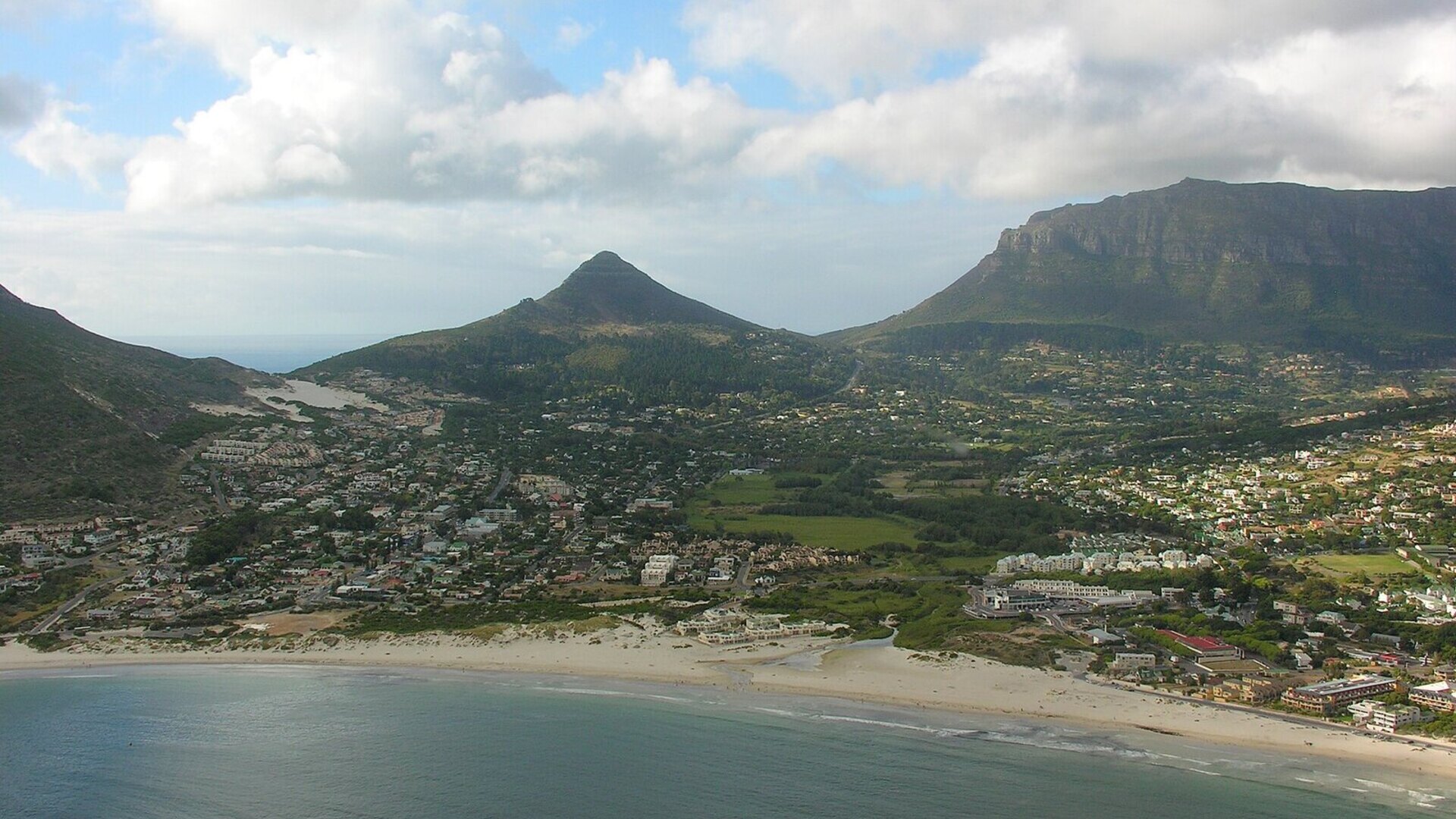 Aerial golden-hour view of the Cape Peninsula at the start of a South Africa honeymoon itinerary