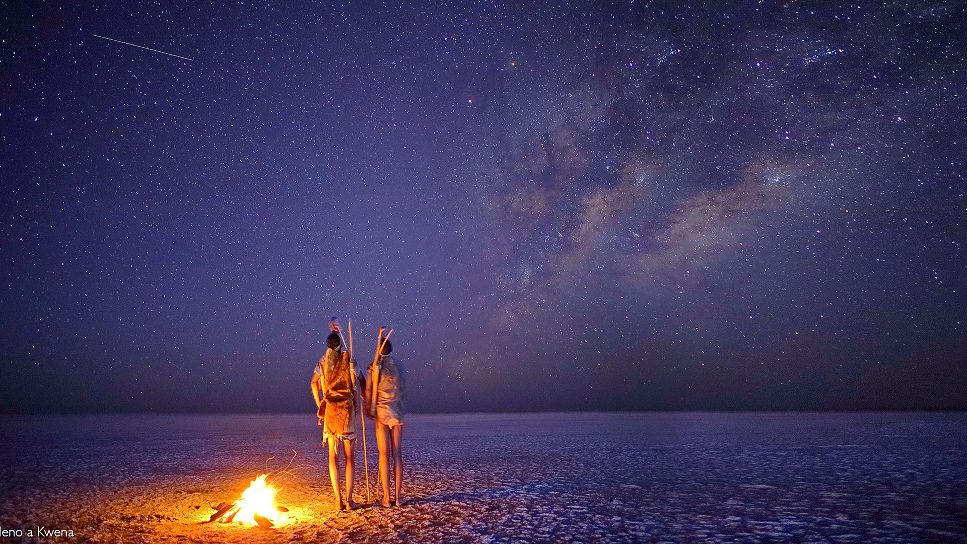 A raised sleeping platform under the Milky Way on the Makgadikgadi salt pans at night