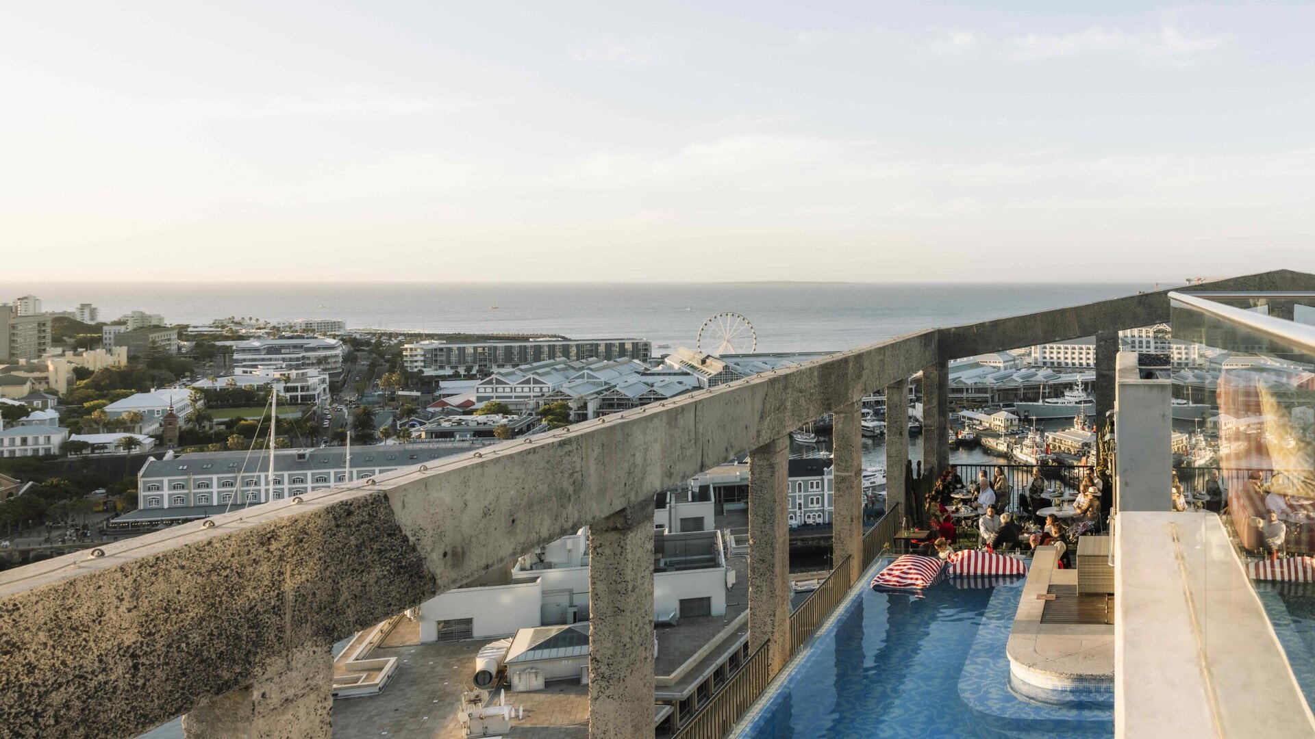 The heated glass-sided rooftop pool at The Silo Hotel looking across the V&A Waterfront and the city