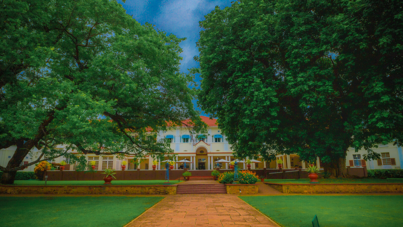 The garden facade of The Victoria Falls Hotel, the grand 1904 colonial landmark, framed by its manicured gardens