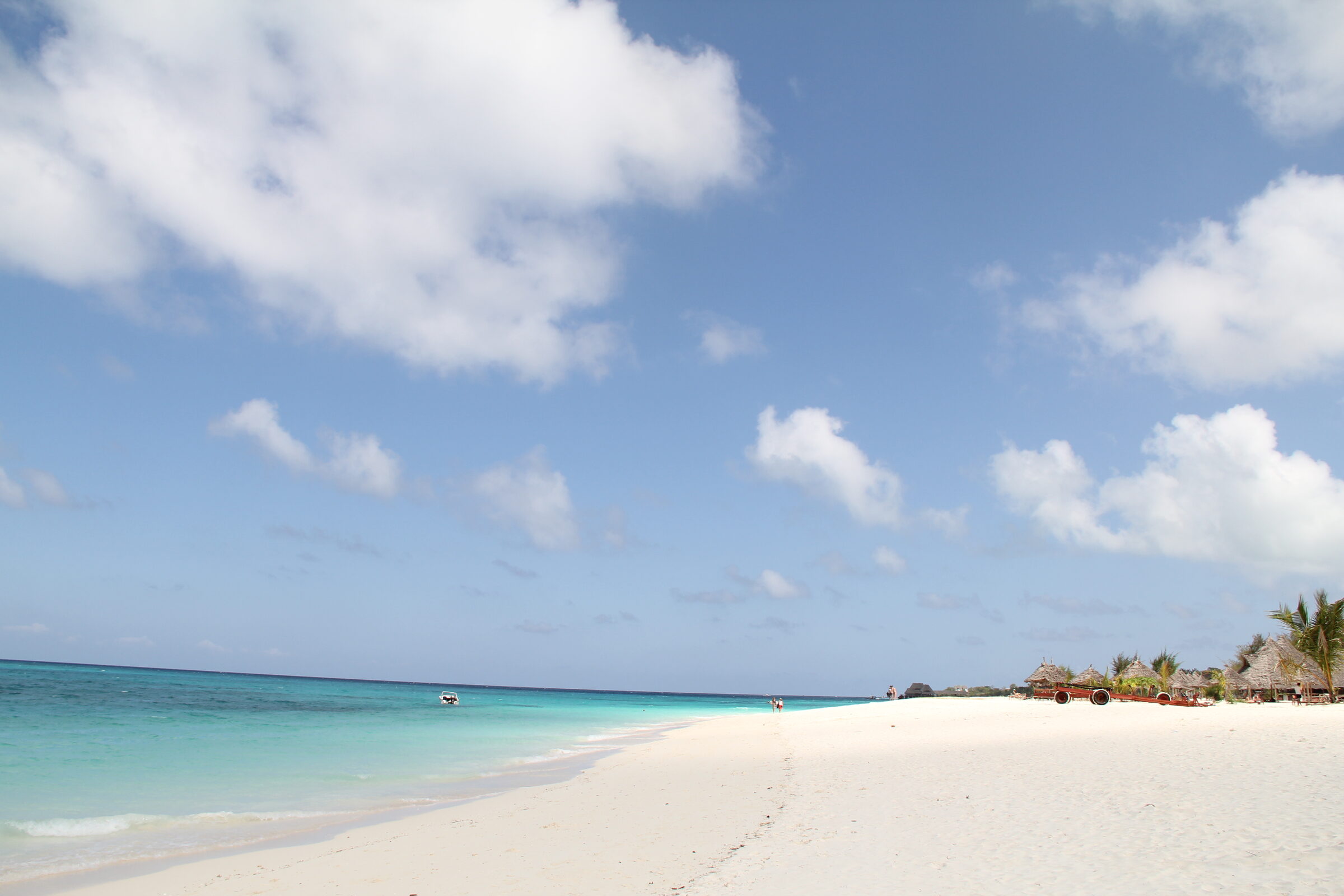 A wooden dhow on the white sand of Nungwi beach, northern Zanzibar, turquoise Indian Ocean beyond — Top 10 Best Zanzibar holiday packages 2026 and 2027