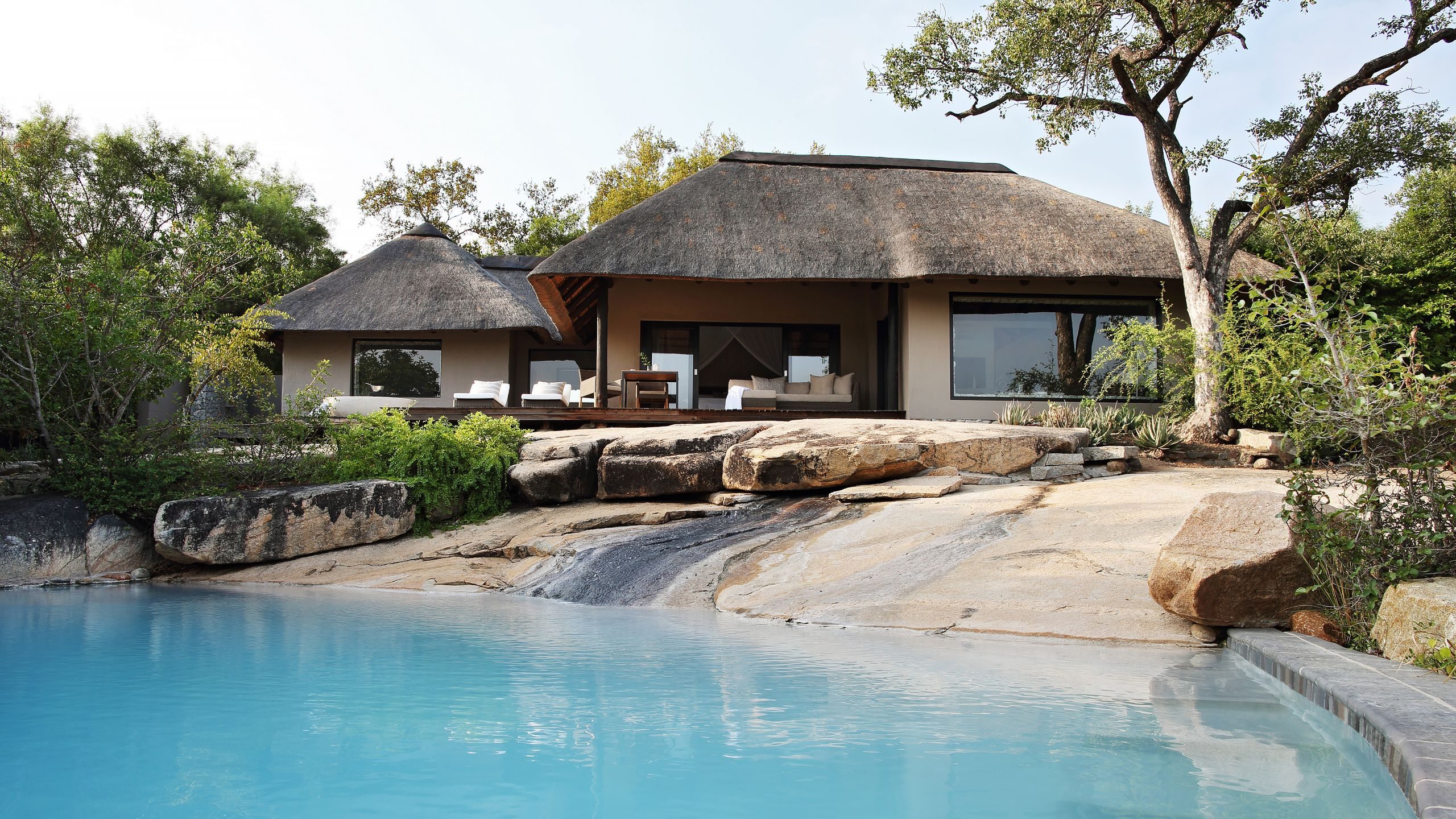 An elegant luxury safari lodge deck overlooking the African bush at sunset in Sabi Sands Game Reserve