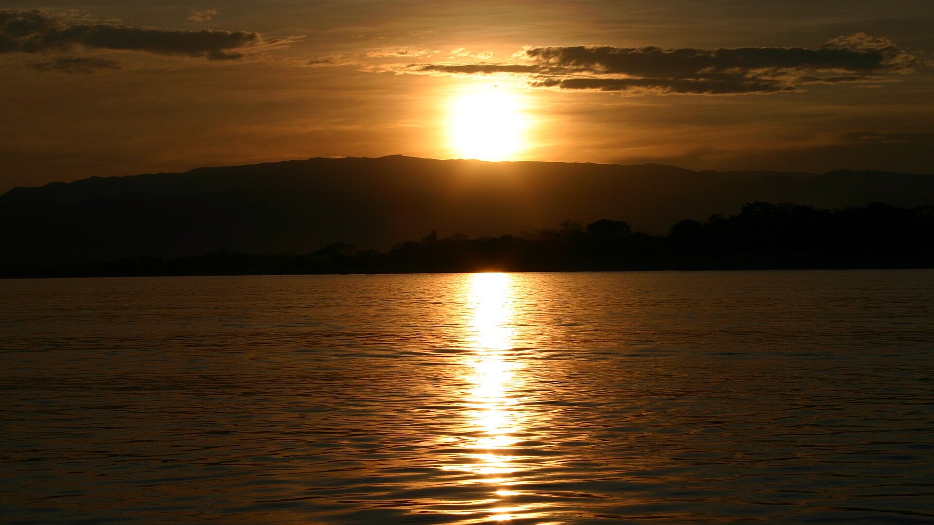 The sun setting in a blaze of gold over Lake Malawi — the shimmering heart of the Warm Heart of Africa