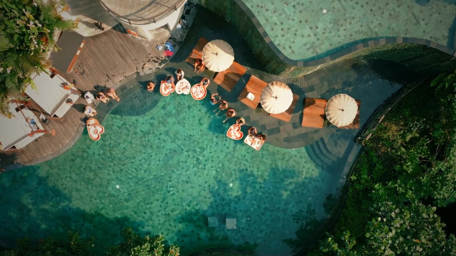 A luxury safari lodge with an infinity pool overlooking the African bush at golden hour