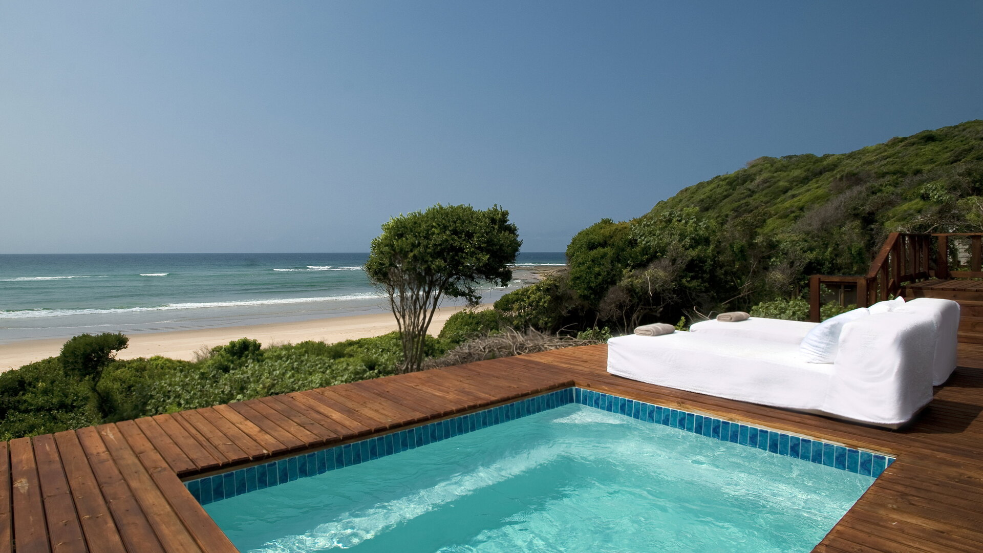 A White Pearl Ponta Mamoli clifftop suite with private plunge pool and daybed overlooking the wild dune coastline of southern Mozambique