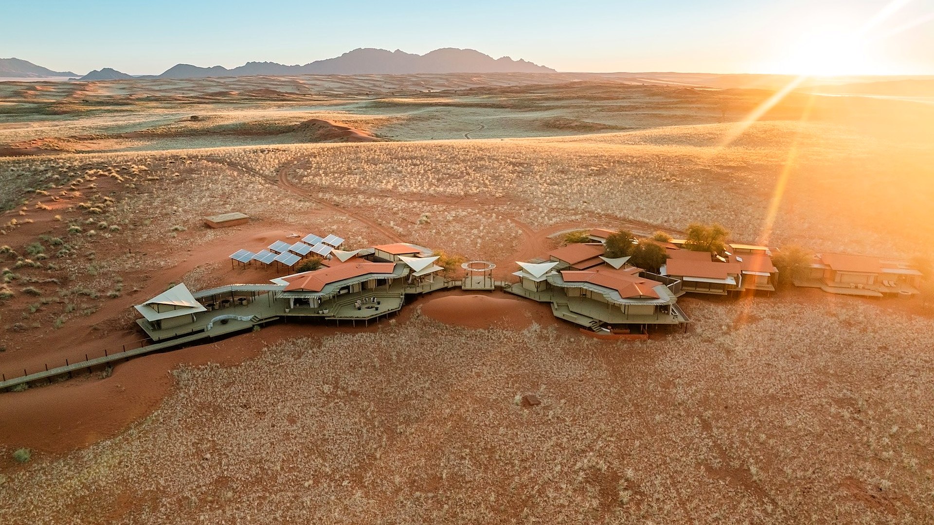 The camps of Wolwedans set in the red dunes of the NamibRand Nature Reserve at sunset