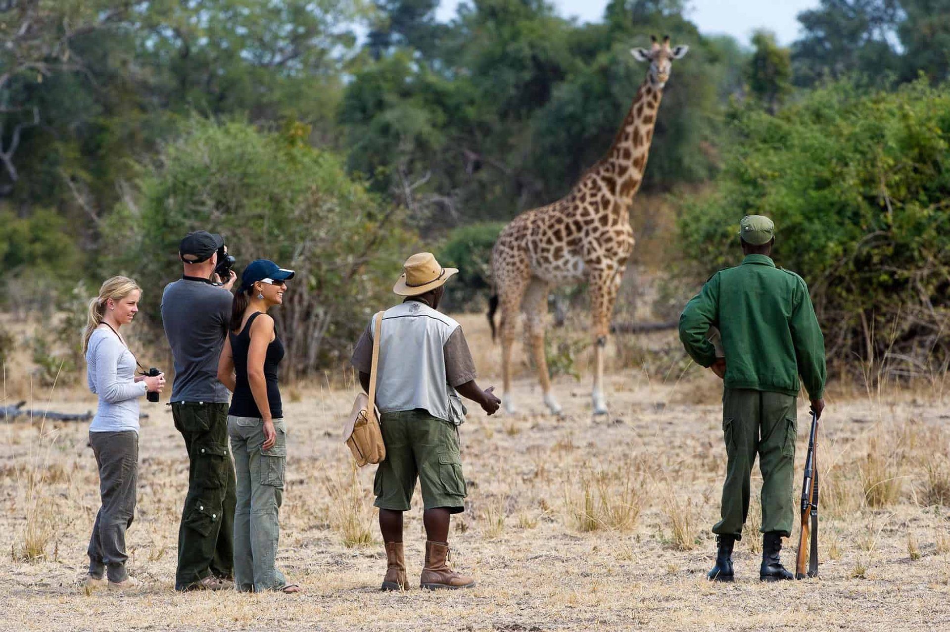 A walking safari group tracking wildlife on foot in the African bush