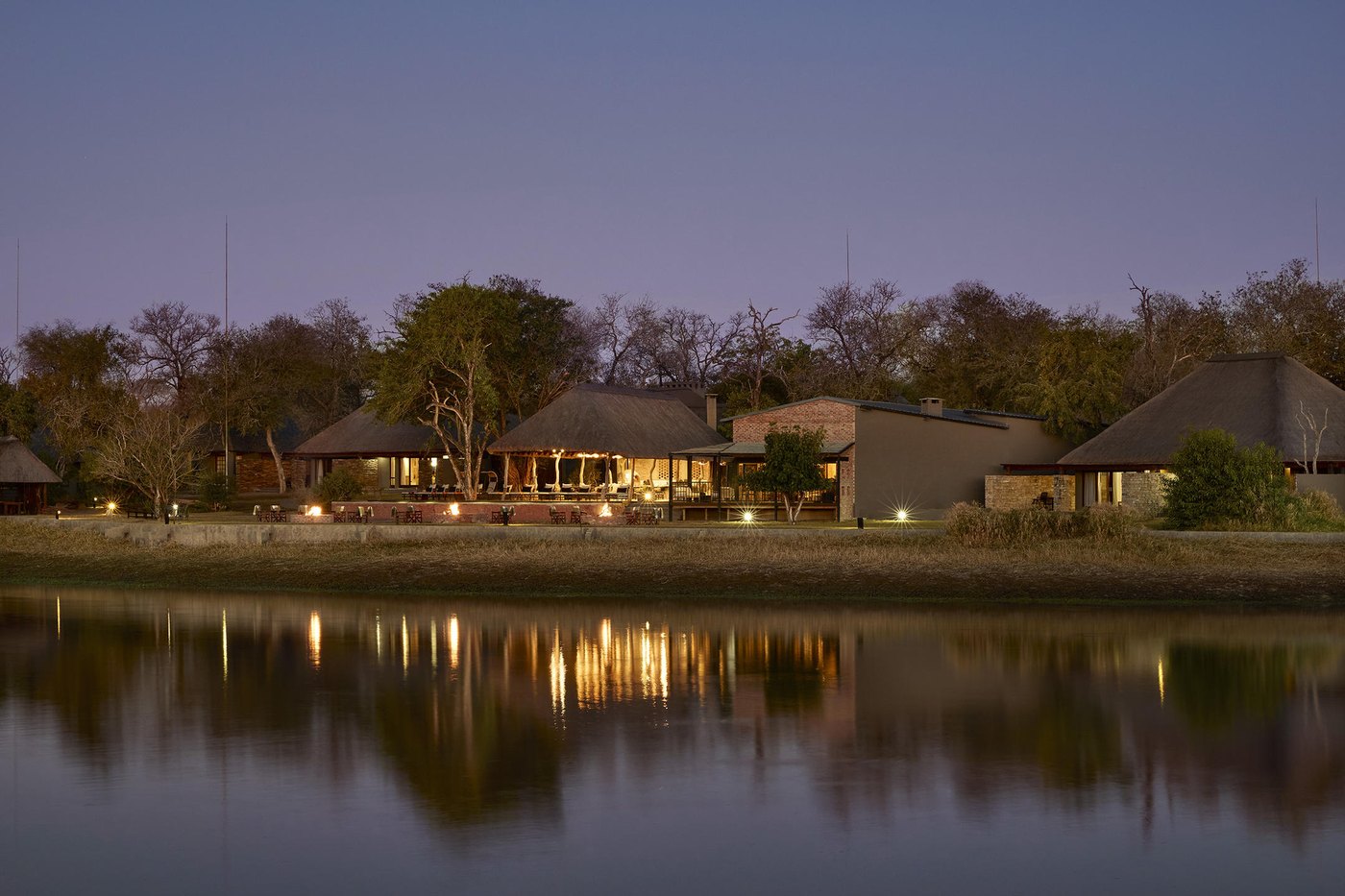 Arathusa Safari Lodge reflected in its waterhole at dusk, Sabi Sands