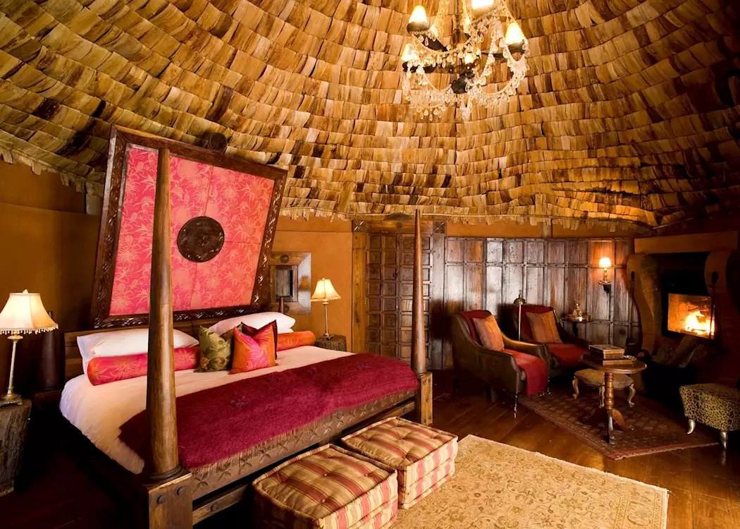 Ngorongoro Crater Lodge — chandelier lounge with antique furnishings and crater panorama