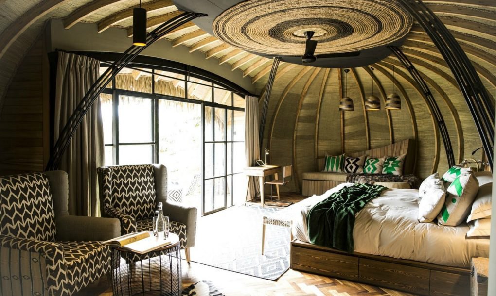 Interior of a villa with fireplace at Bisate Lodge
