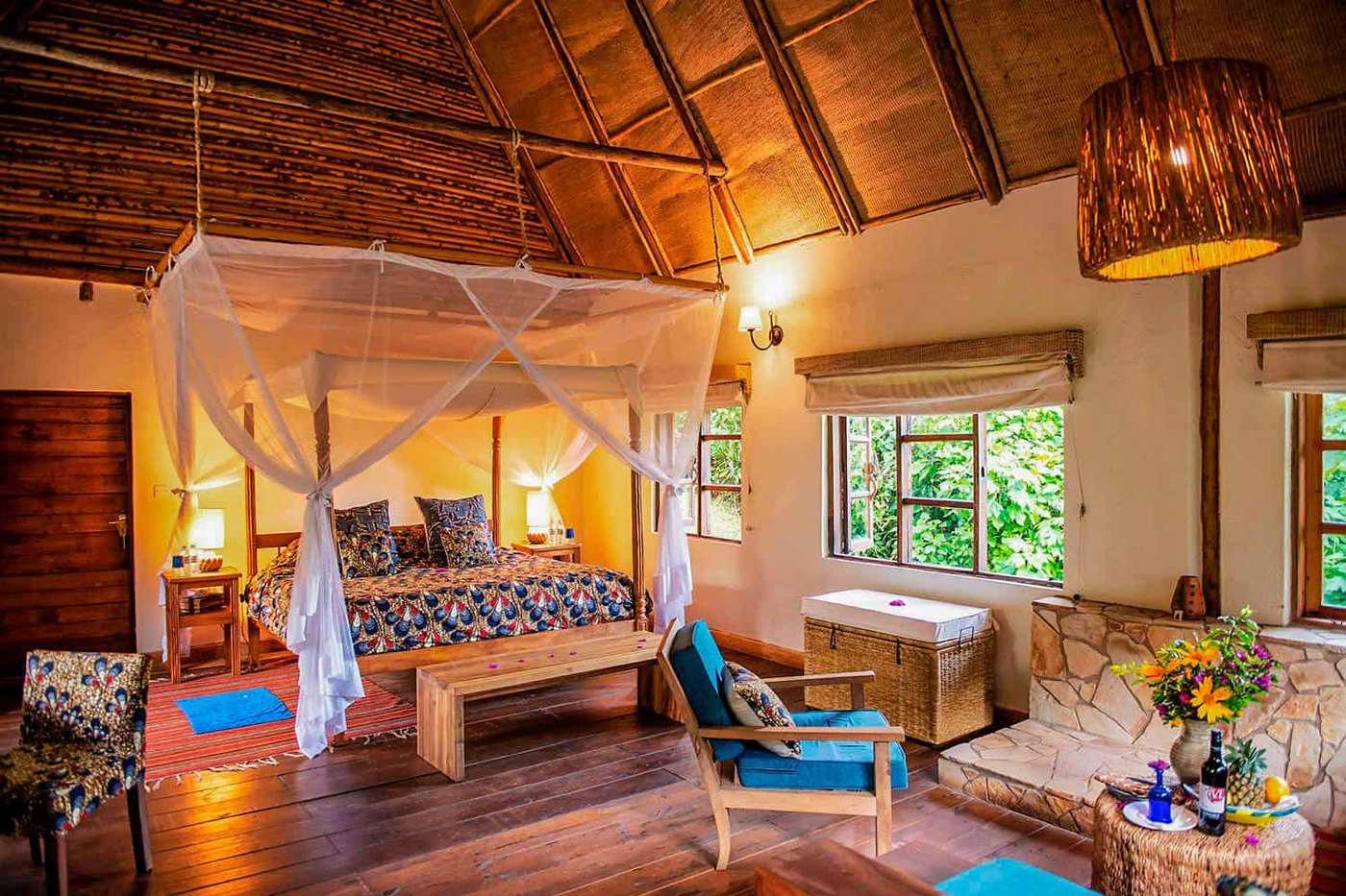 Bwindi Lodge banda gazing into the misty Bwindi Impenetrable Forest at golden hour