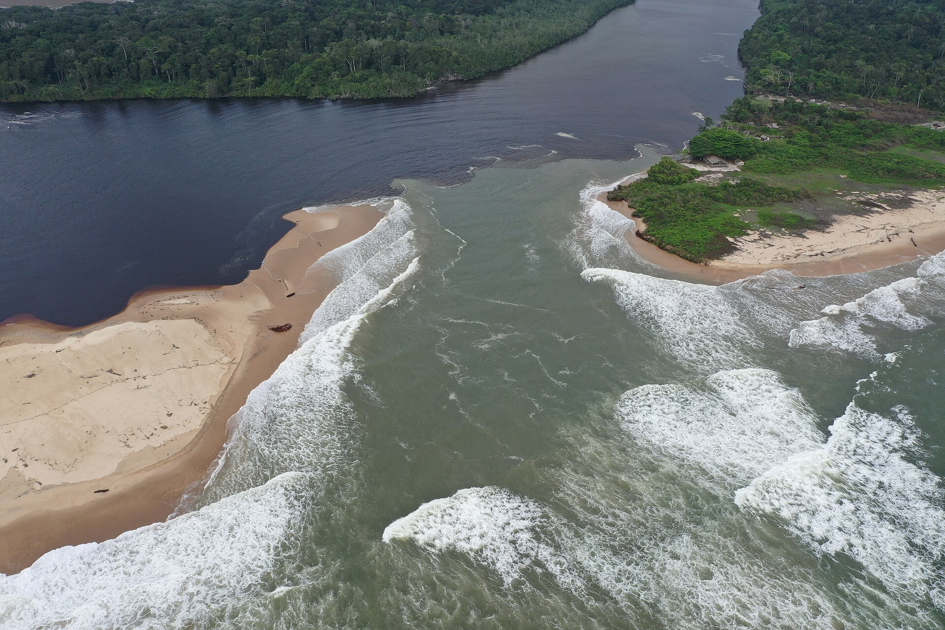 Aerial view of a river mouth meeting the Atlantic Ocean in Conkouati-Douli National Park