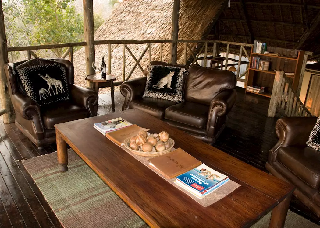 Intimate dining setup at Katavi Wildlife Camp under the stars with lantern light