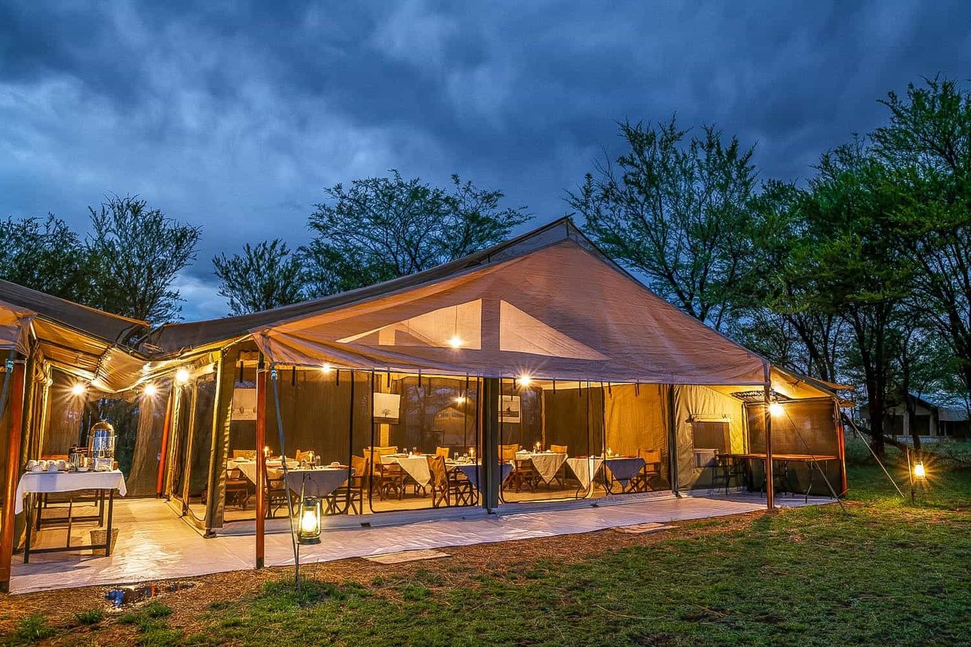 Open-air dining and campfire at Kati Kati Tented Camp on the Serengeti plains