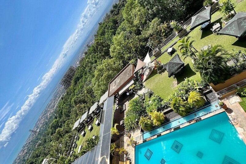 Hotel exterior with tropical gardens and entrance