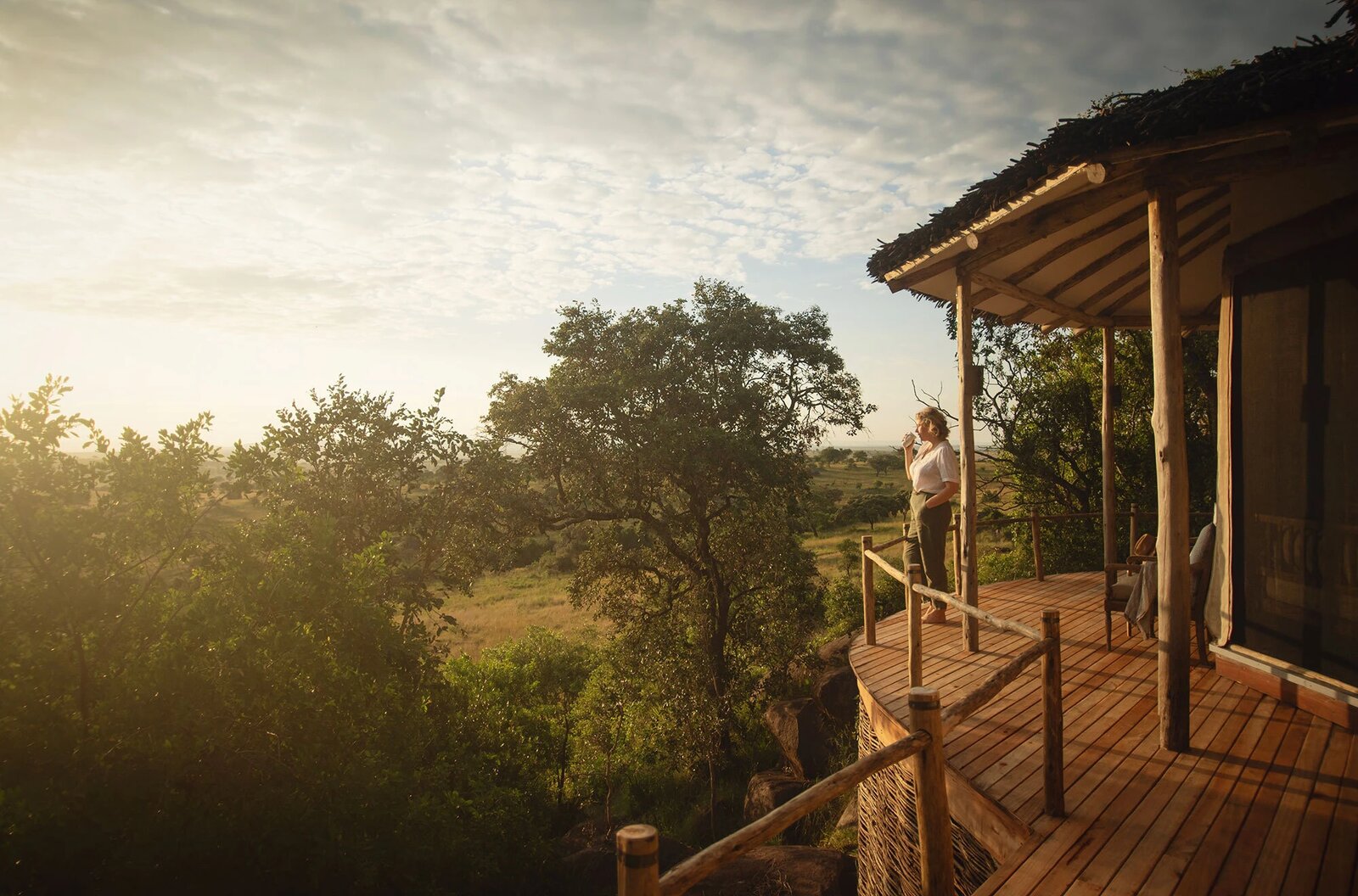 Guest deck at Lamai Serengeti at sunset looking out over the northern Serengeti toward the Mara River