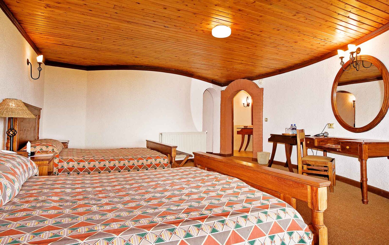 Ngorongoro Sopa Lodge gardens and pool with crater backdrop