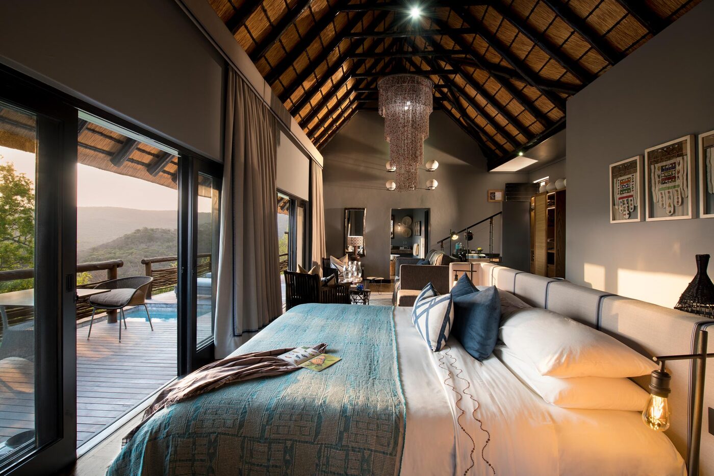 andBeyond Phinda Mountain Lodge suite bedroom opening to a private deck and pool with bush views