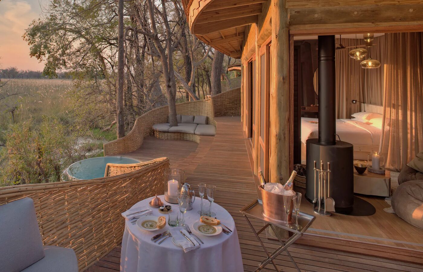 andBeyond Sandibe suite private deck with romantic dinner at sunset, Okavango Delta Botswana