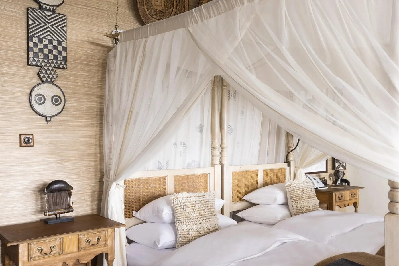 Singita Sasakwa Lodge suite bedroom with four-poster and Serengeti decor, Grumeti Tanzania all-inclusive luxury safari