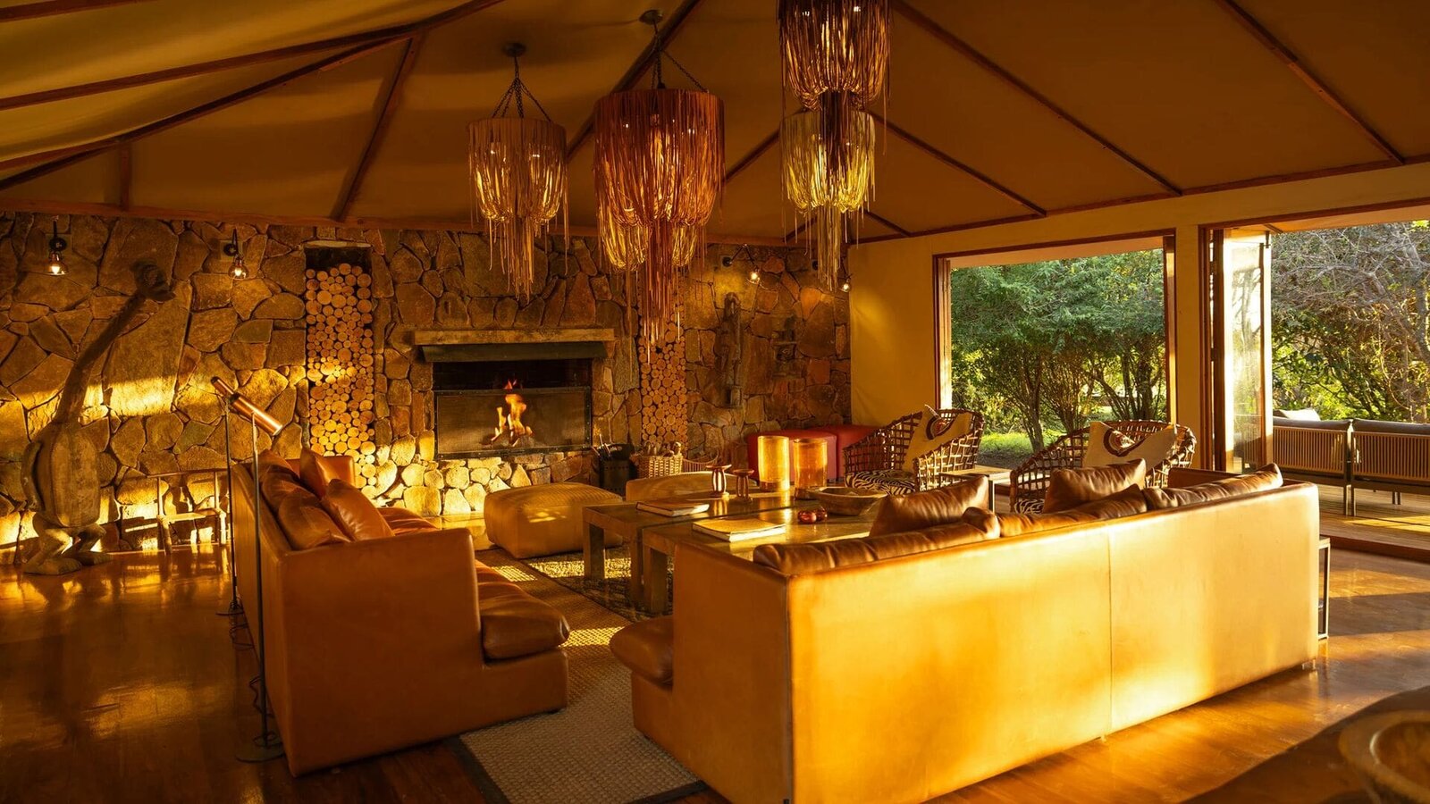 Main lounge at Sayari Camp with fireplace and relaxed seating