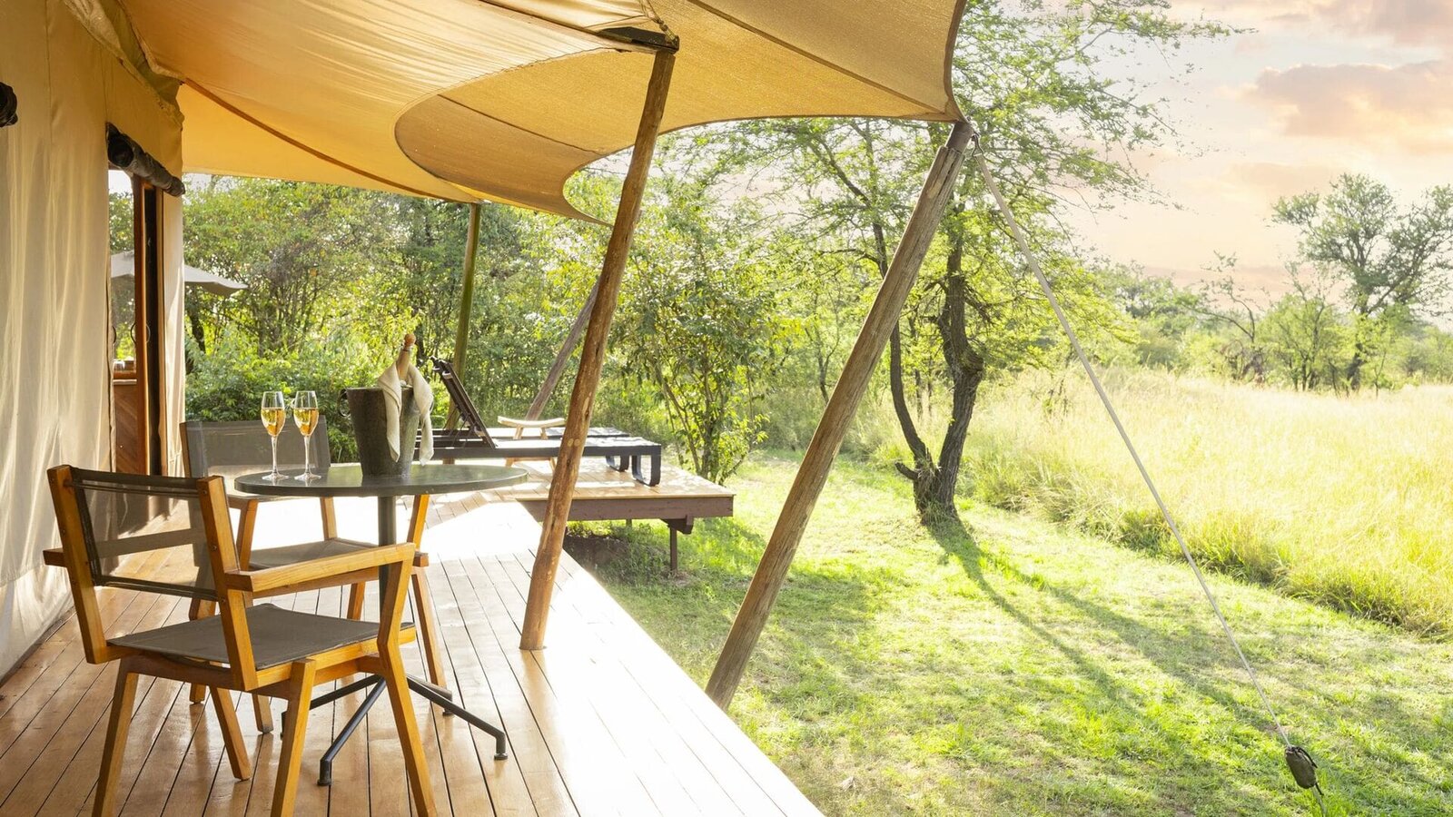 Private deck at Sayari Camp set for a meal overlooking the northern Serengeti grassland