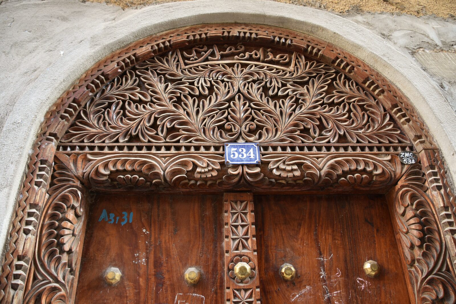 Intricate carved door detail with geometric patterns, Stone Town