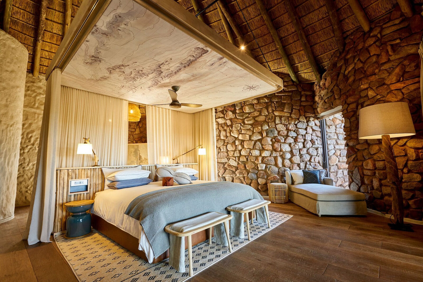 Tswalu Kalahari stone-and-timber bedroom opening to the reserve