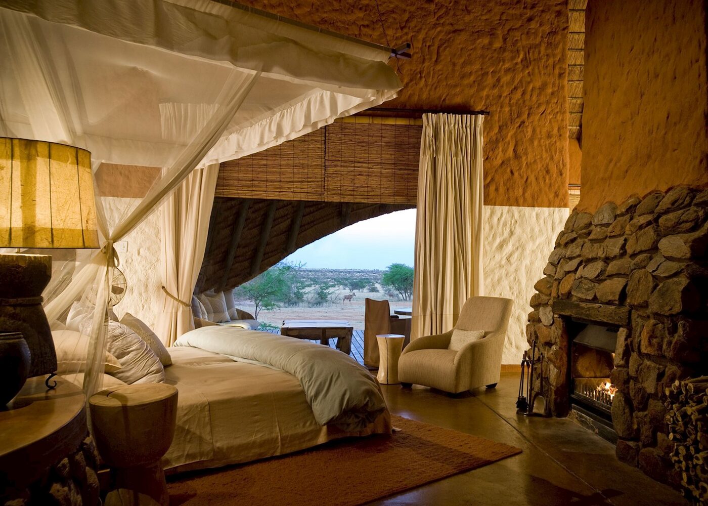 Tswalu Kalahari The Motse four-poster suite with fireplace and desert view, Northern Cape