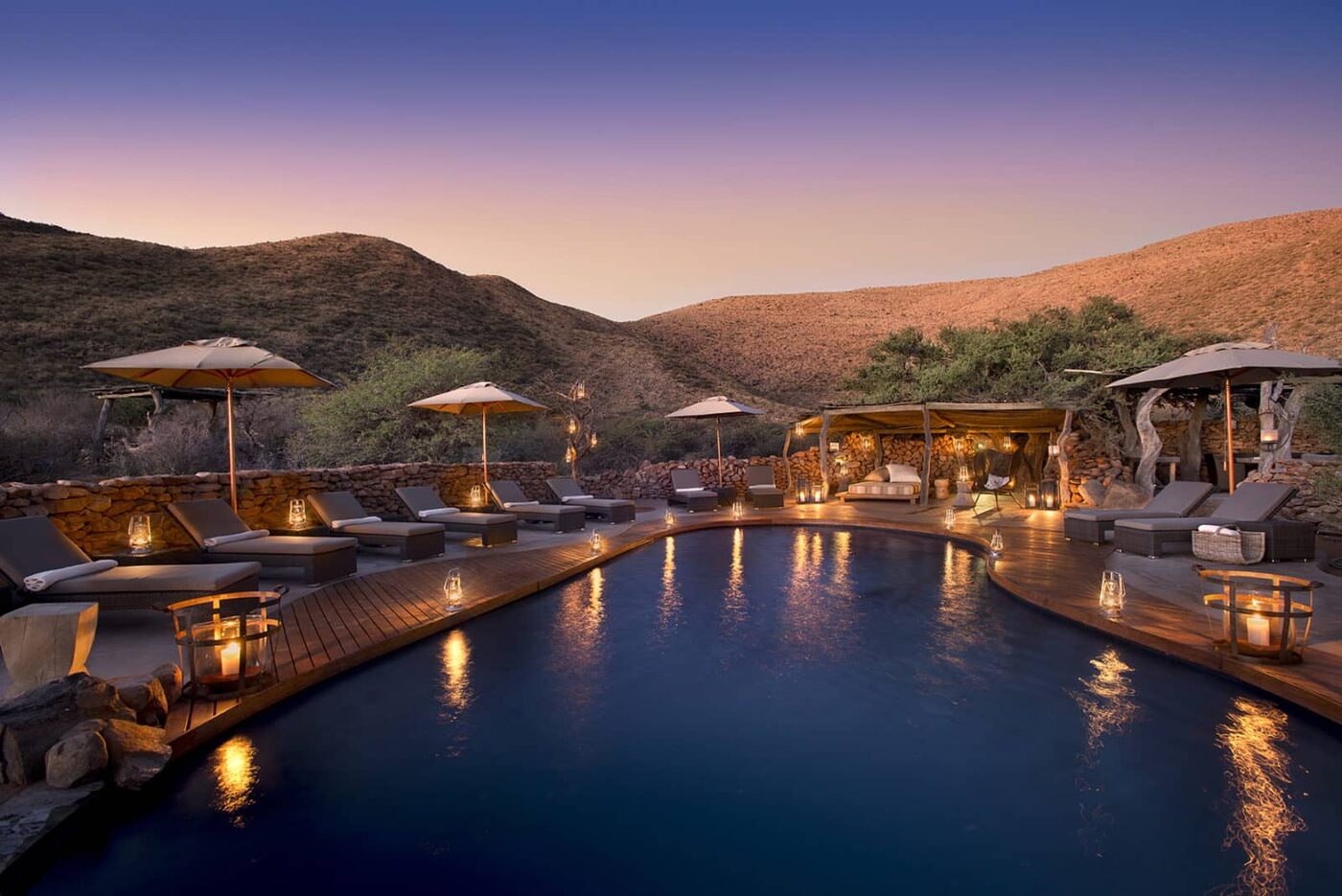 Tswalu Kalahari Tarkuni homestead pool at sunset overlooking the Korannaberg mountains